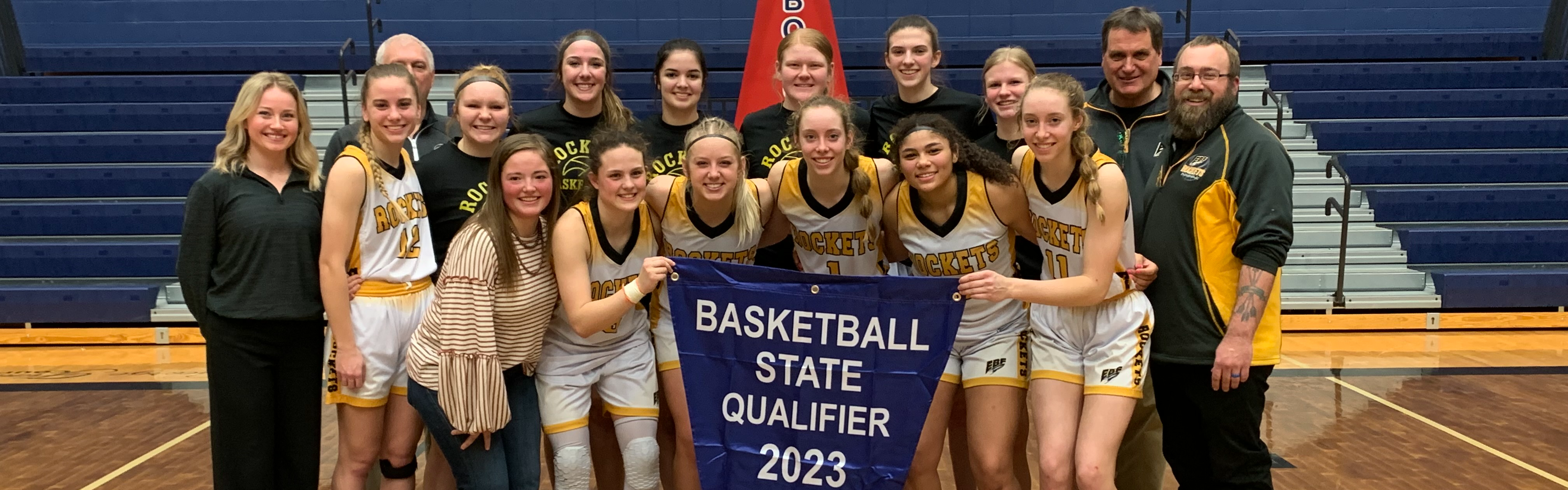 Picture of the state qualifying EBF girls basketball team with their banner