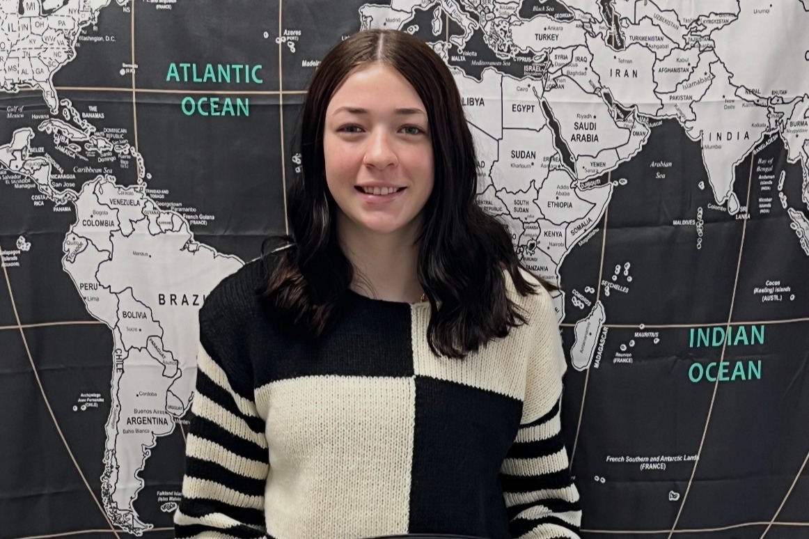 Picture of teenage girl holding the EBF Student of the Week trophy. She is consistently respectful toward her teachers and does a great job advocating for herself and others.