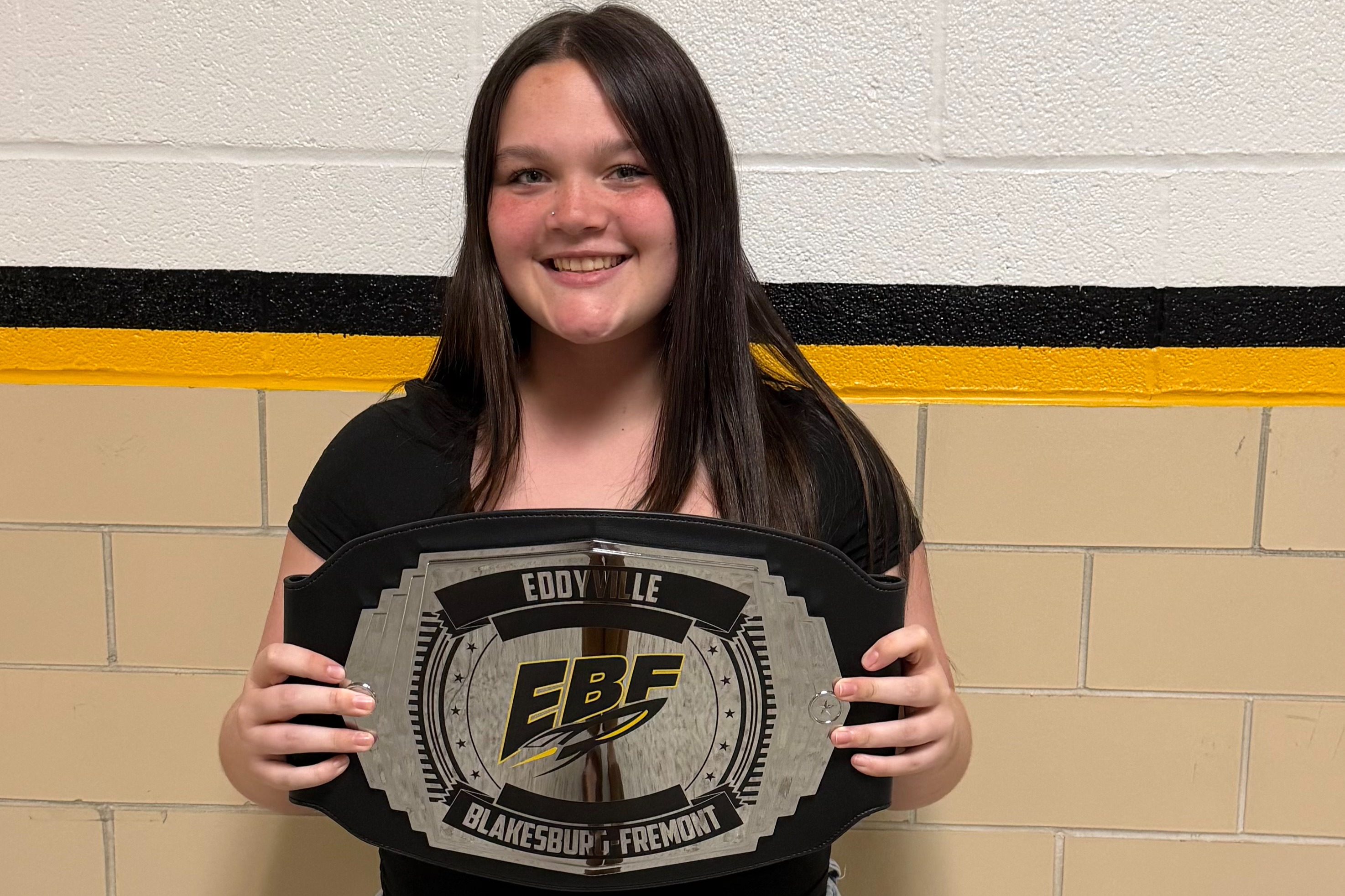Picture of young lady holding certificate for jr./sr. high student of the week