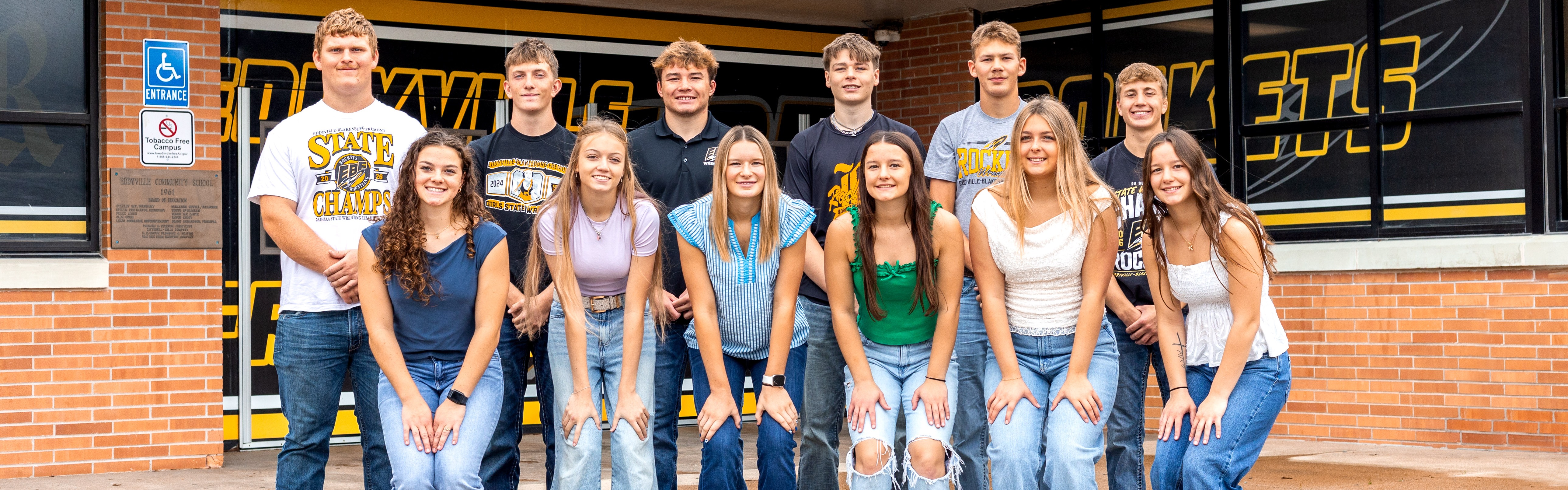 EBF homecoming court posing for picture in front of the school