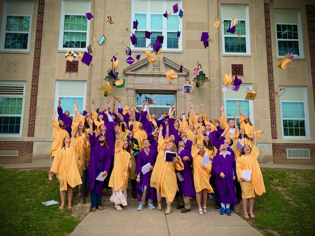 Students throwing up hats at graduation