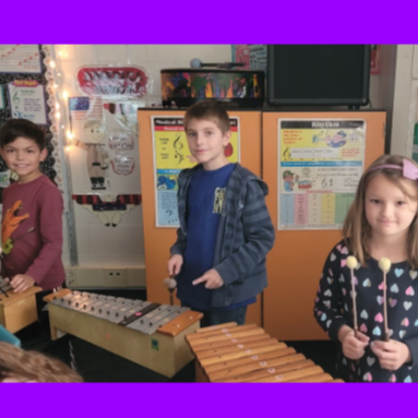 3 students playing a xylophone