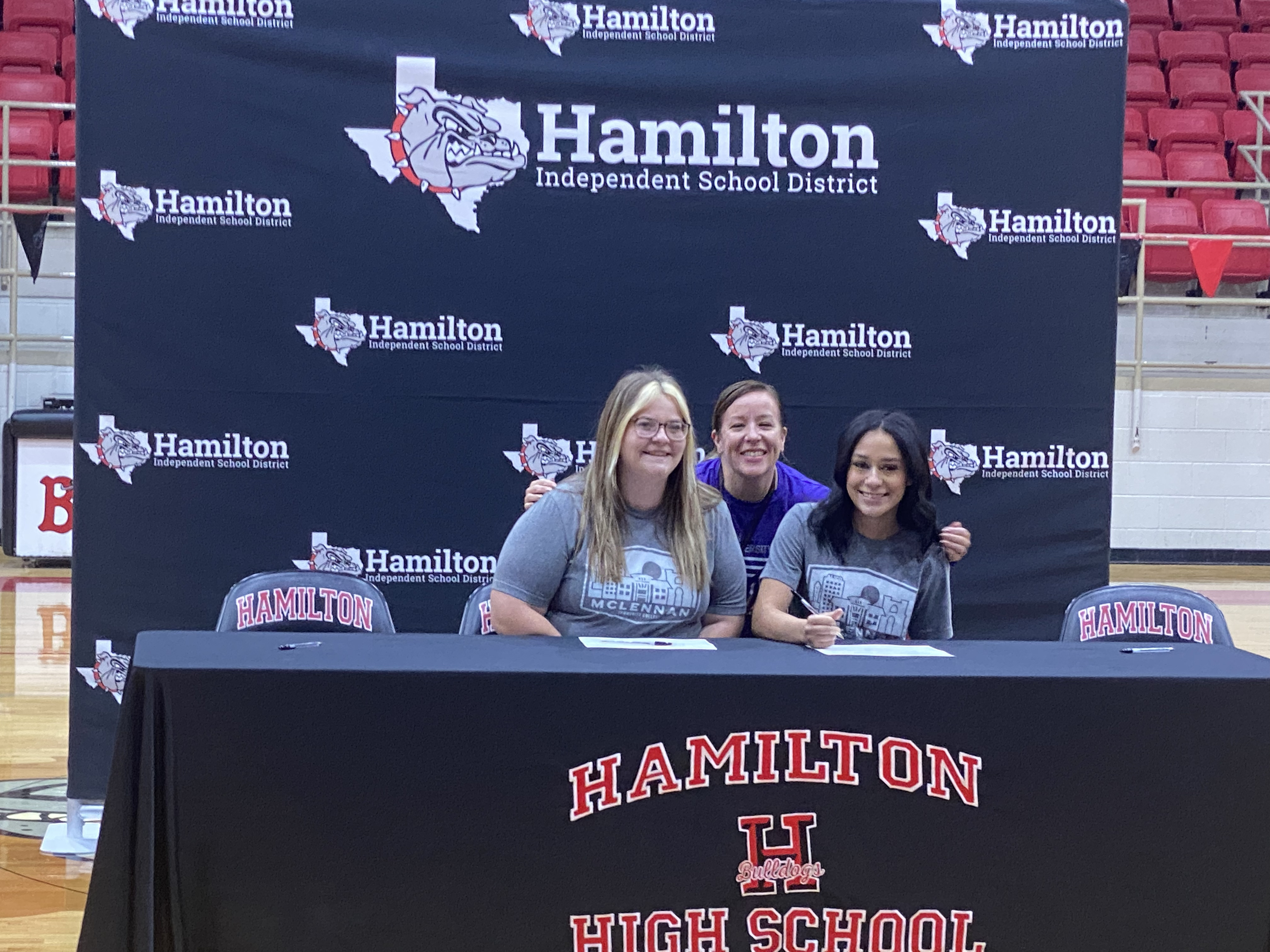 Chasiti Ranaghan  and Jade Santiago sign with McLennan Community College. MCC Alumni Shannan Roberts welcomes them to the family. 