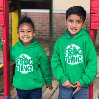 school aged kids wearing green hoodies