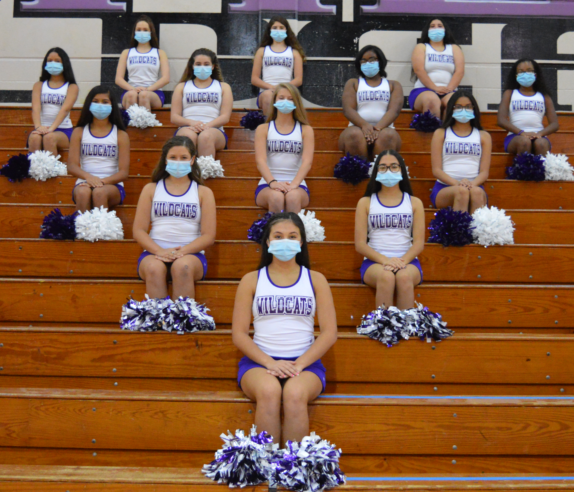 Cheerleader group picture socially distanced and with masks on