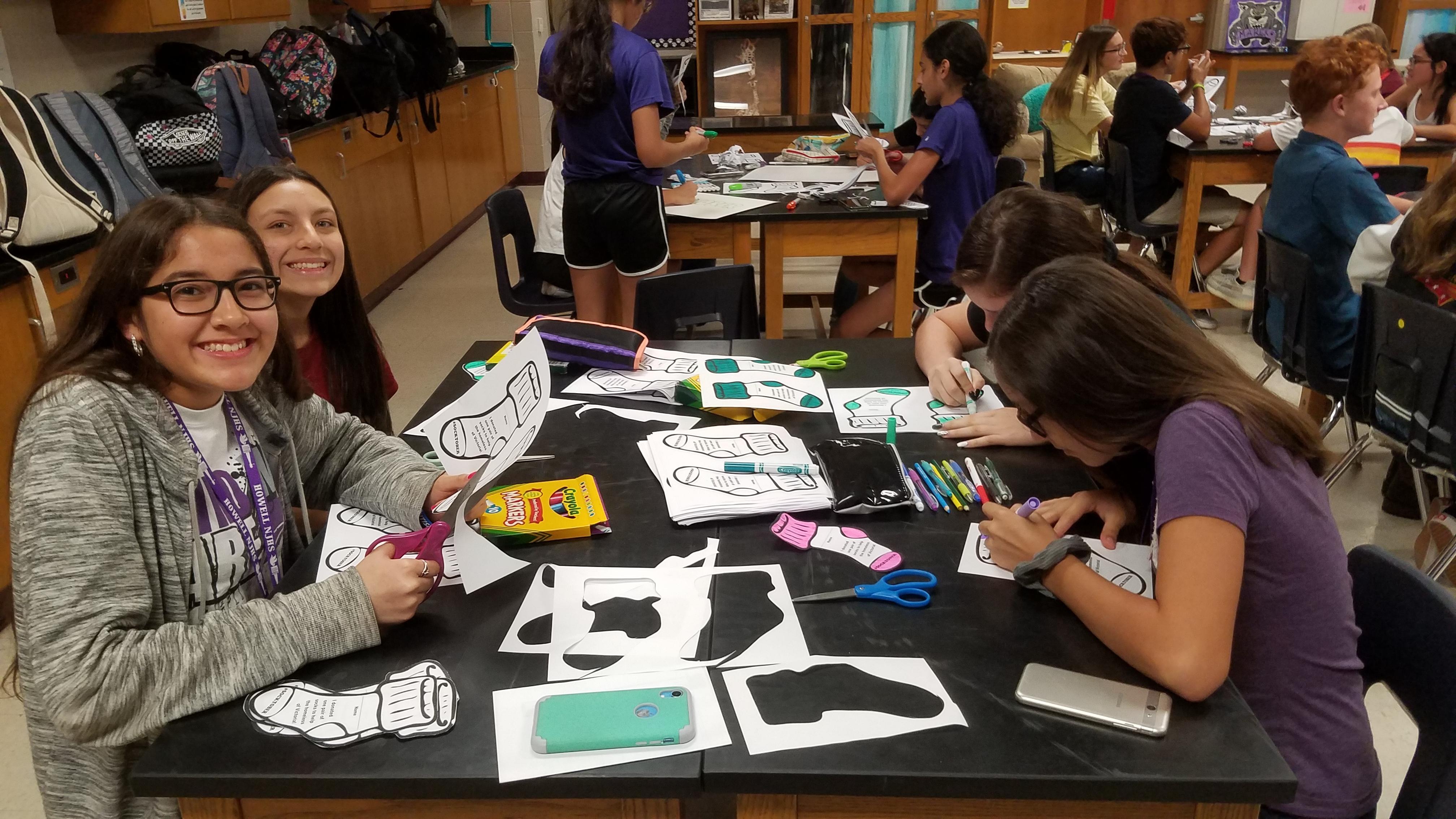 Students making sock donation markers