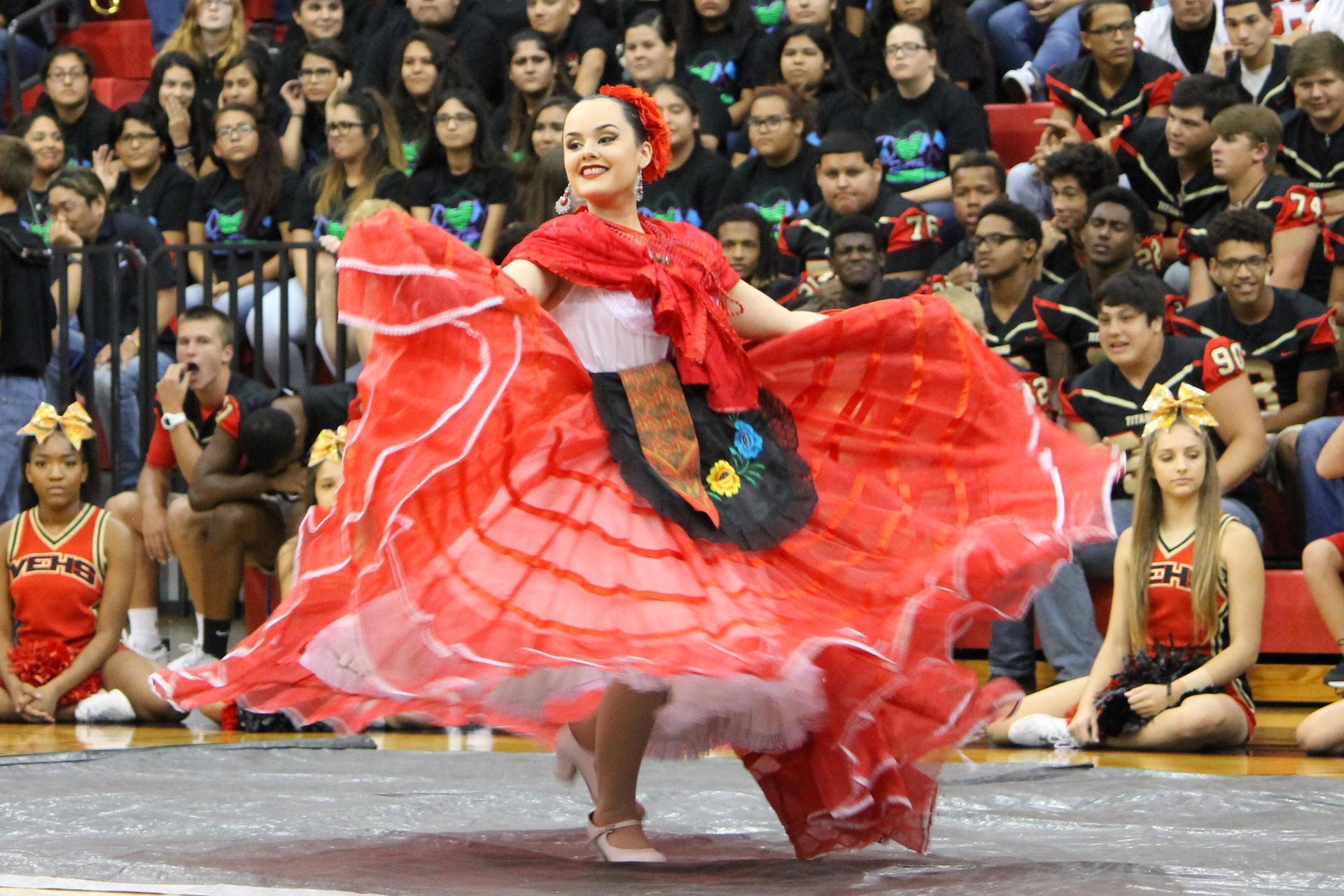 Ballet Folklorico:  Performer in a red dress dancing.