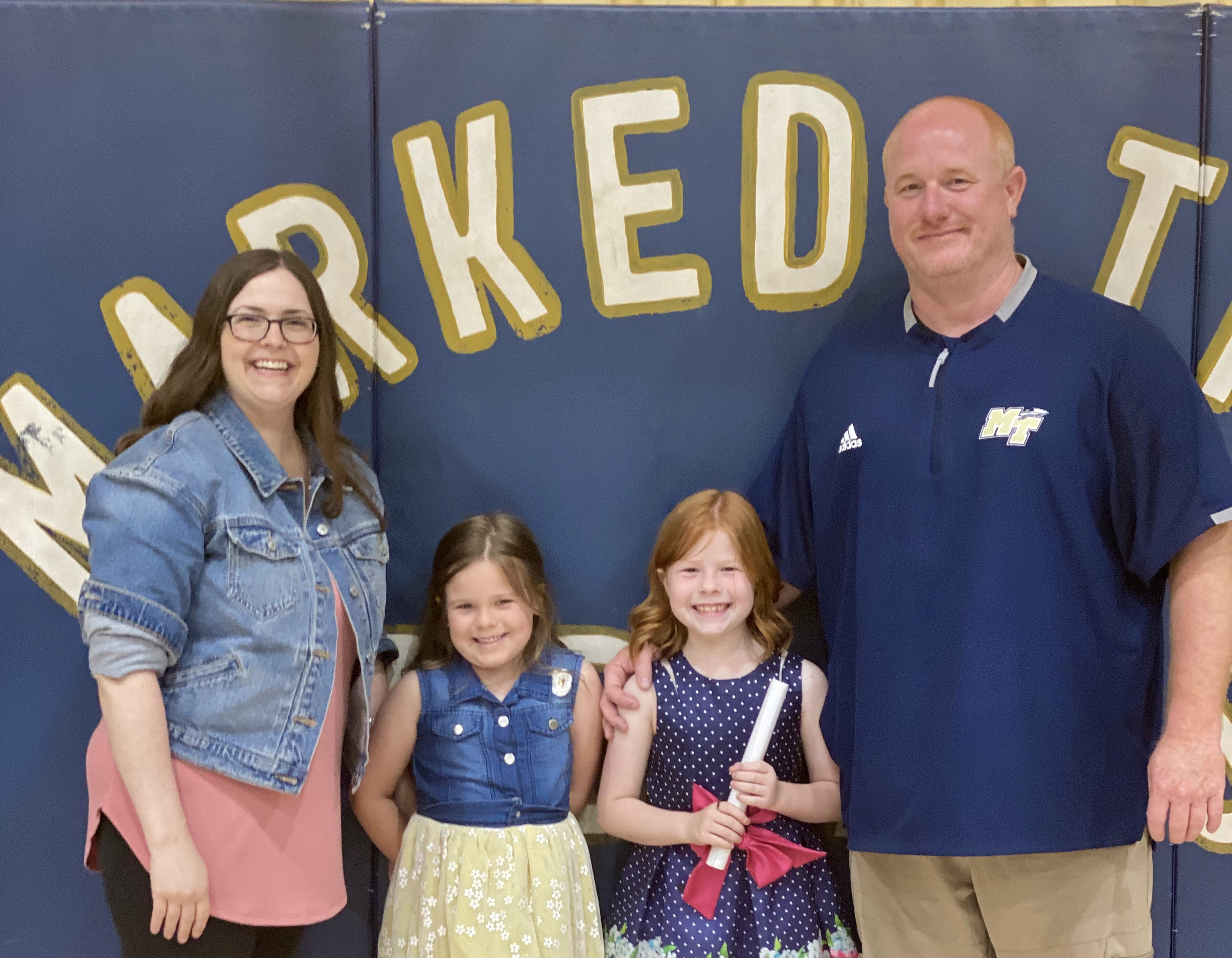 Supt. Wright smiling with his family on the Marked Tree basketball court