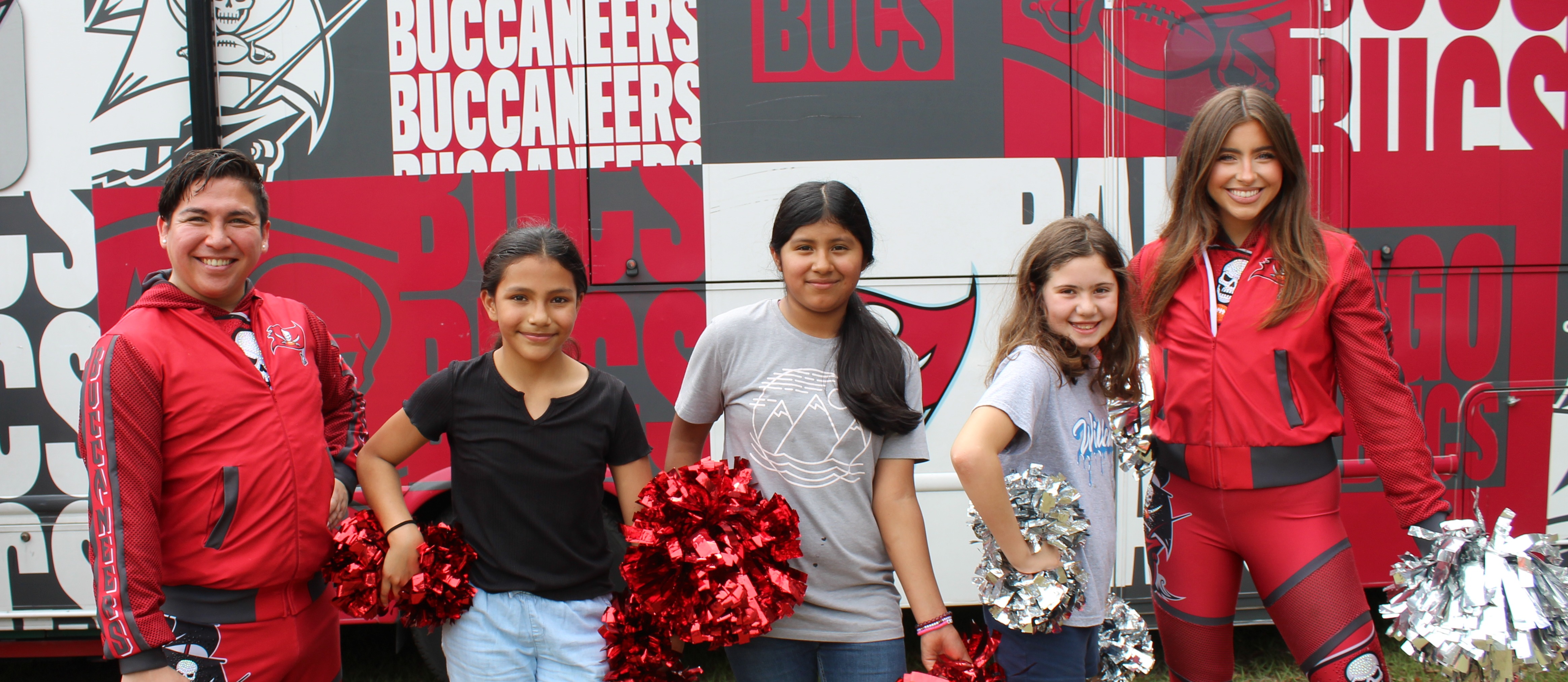 students with buccaneers cheerleaders