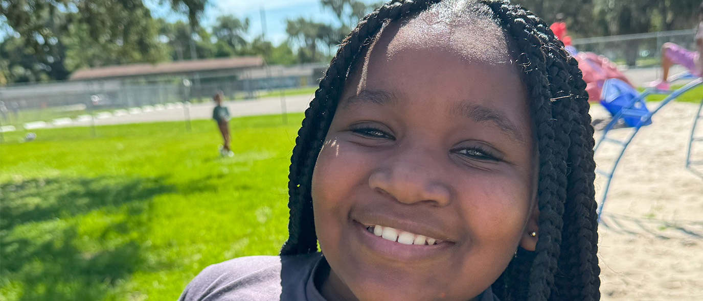 close up of a young girl smiling at the camera