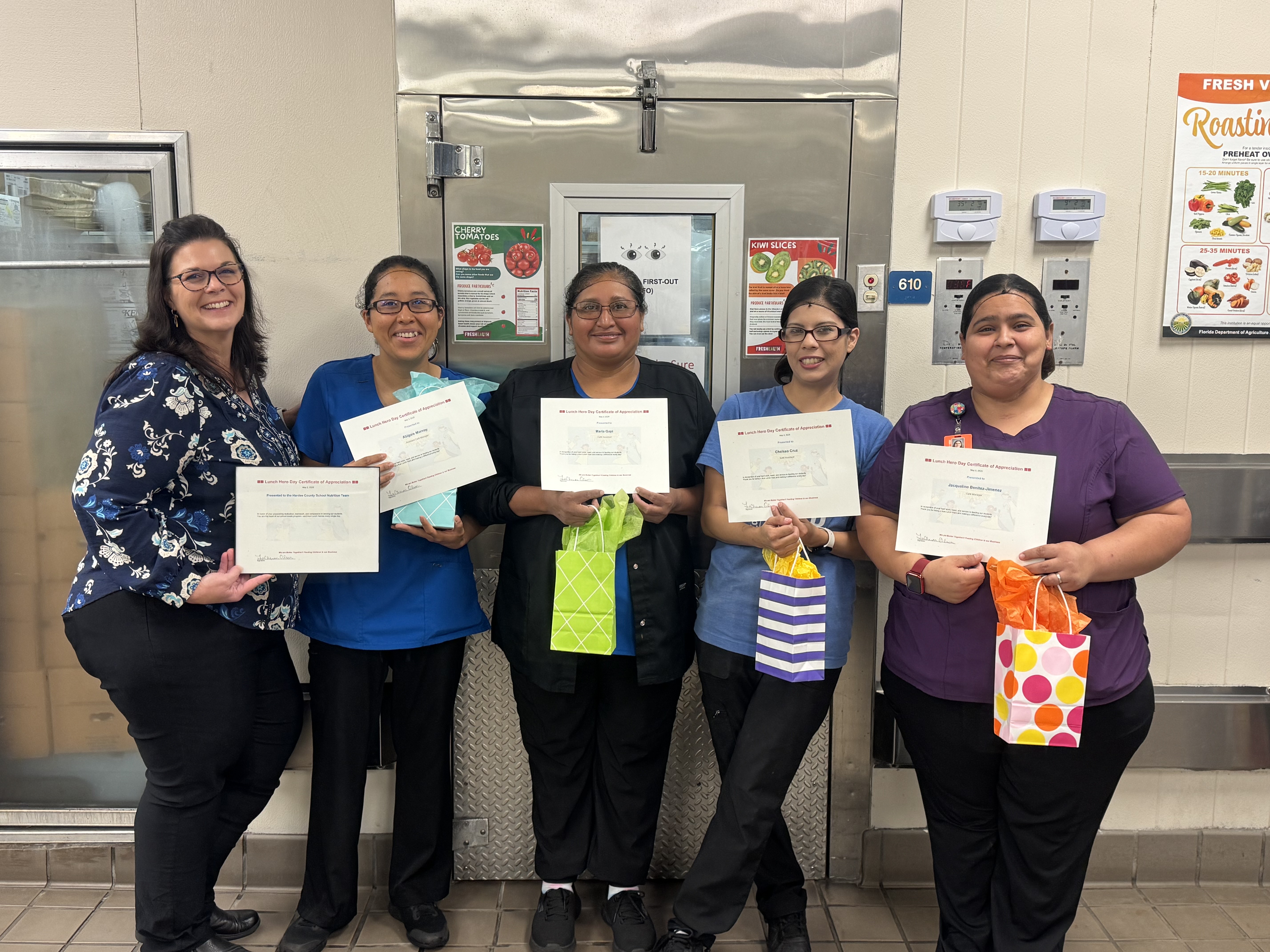 a line of food service workers with certificates for School Lunch Hero Day