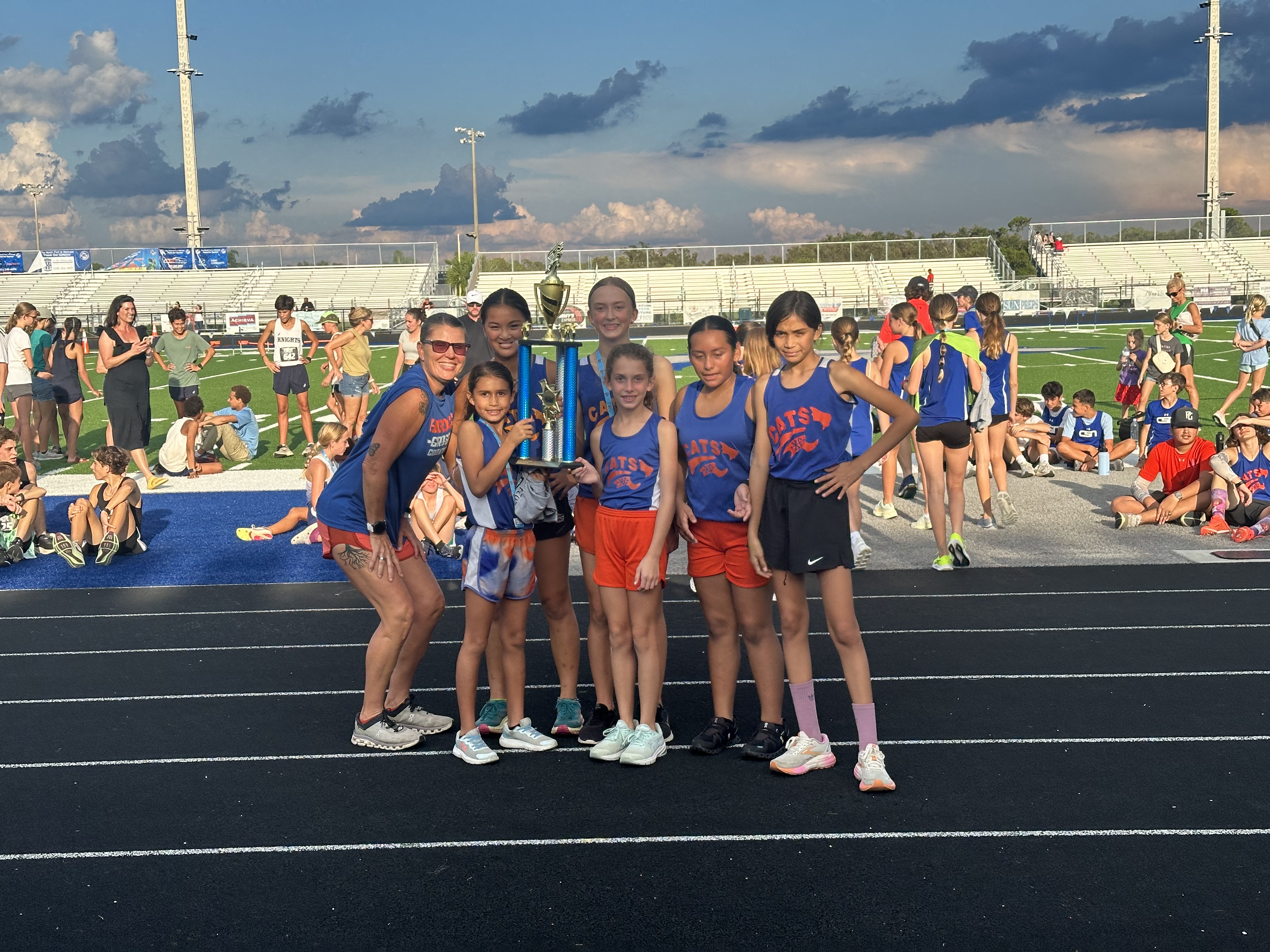 cross country team with a trophy
