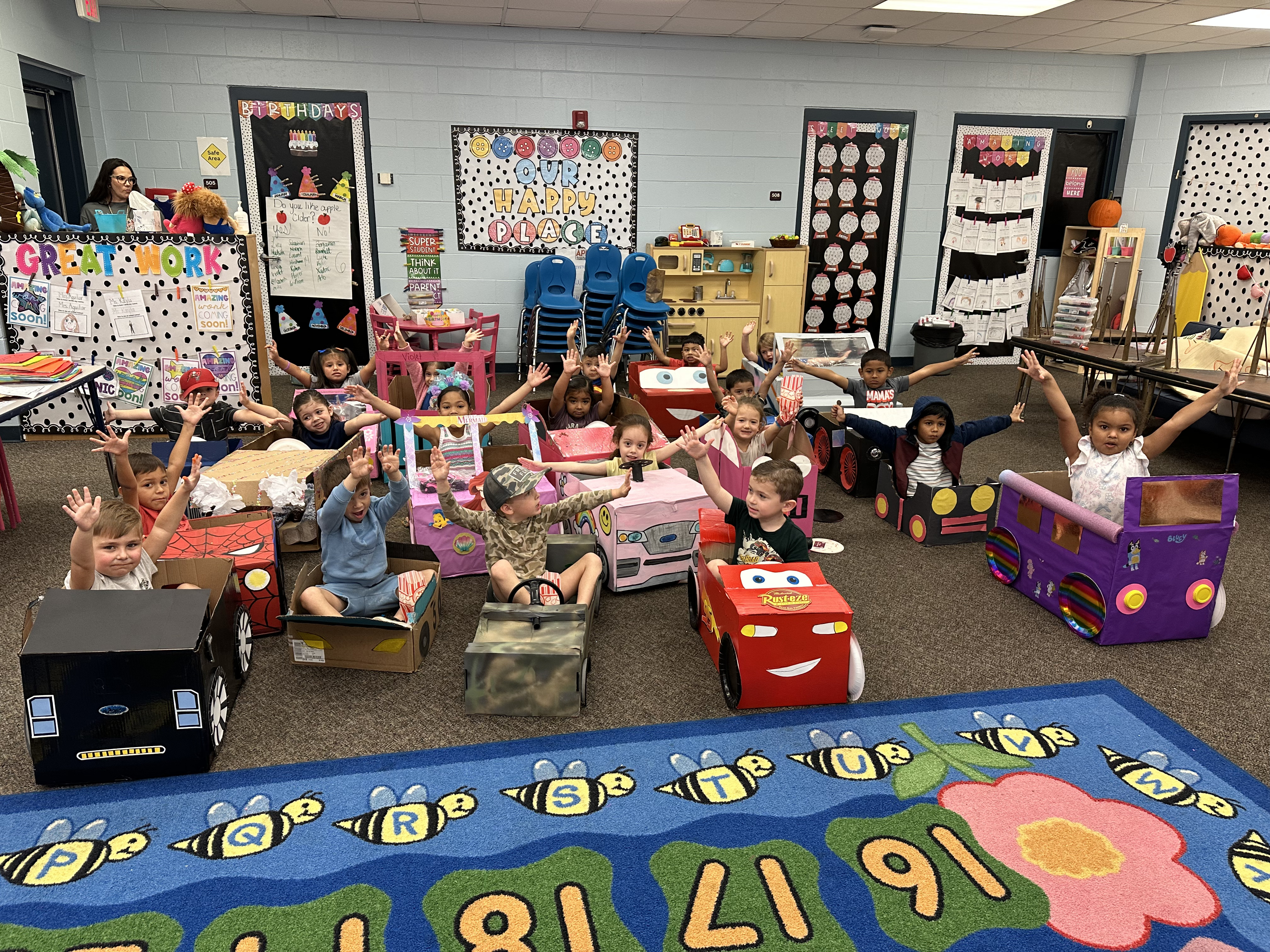 young students in cardboard cars