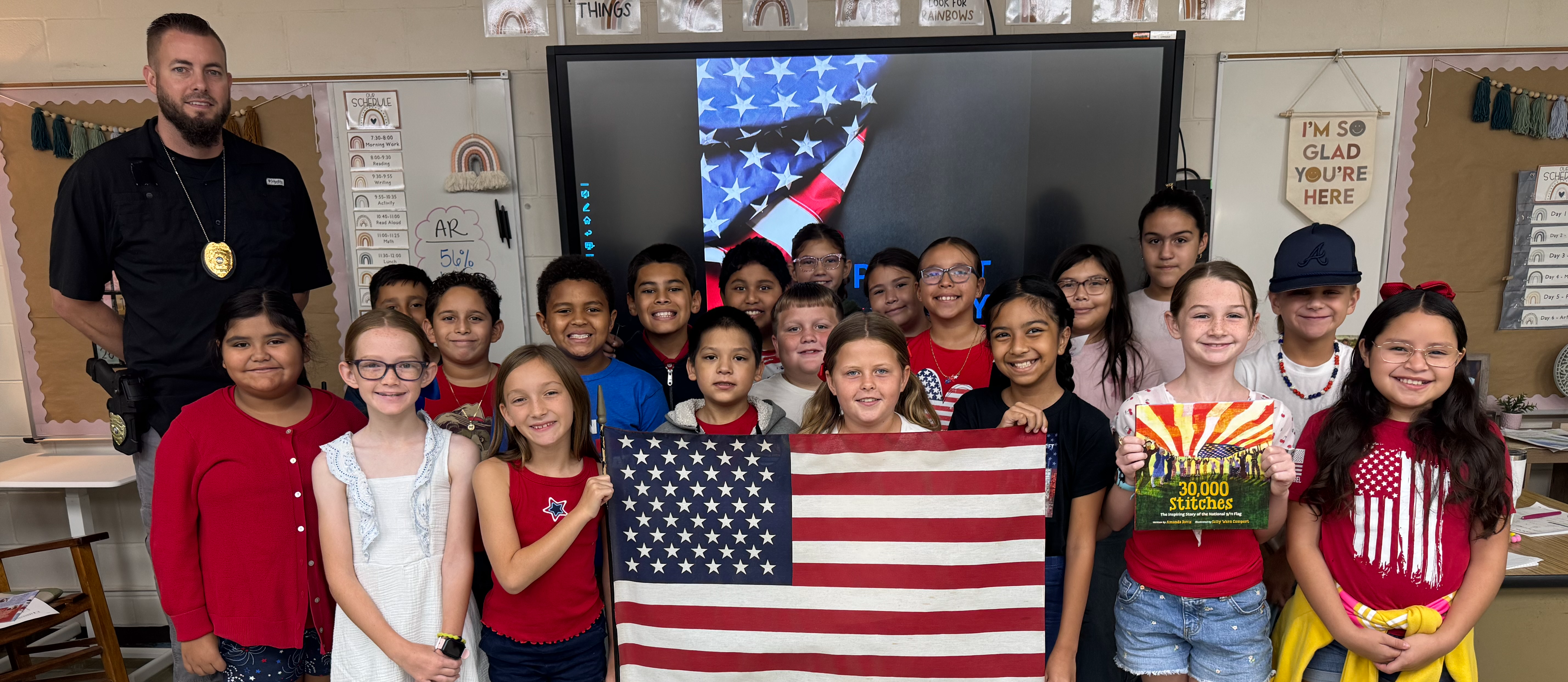 class standing with american flag