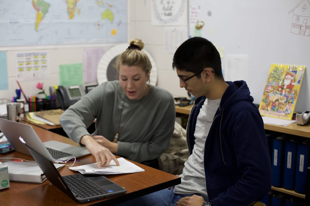 Two students working together in the laptop