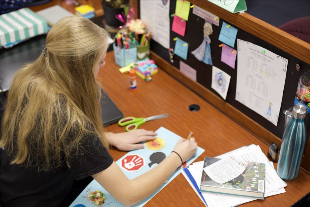 Student working with a post-it notes