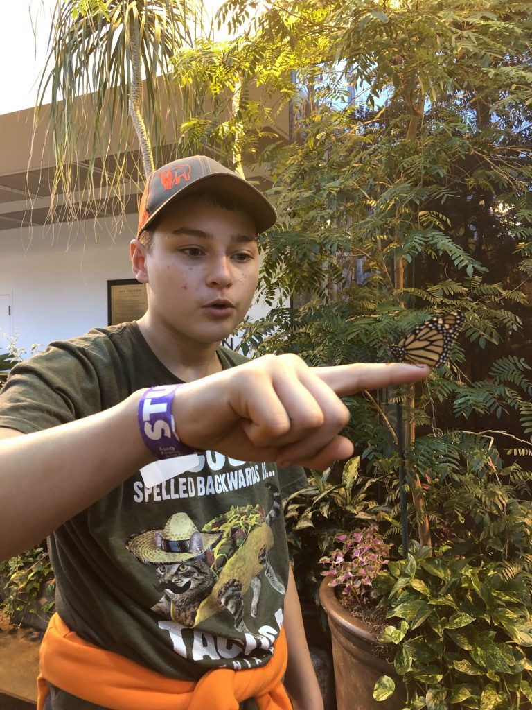 A student pointing at a camera