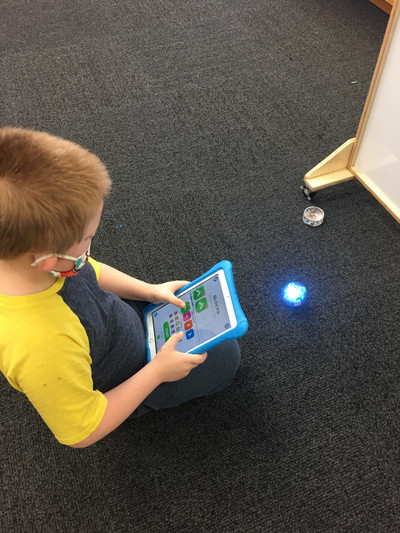 A kid playing with his learning ipad