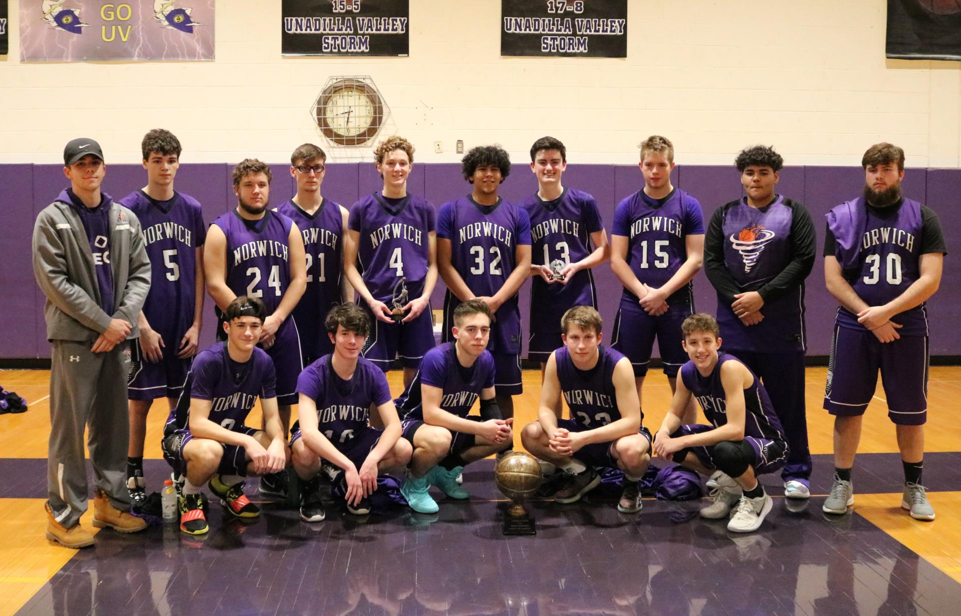 Boys Basketball Team inside the gym in their uniforms