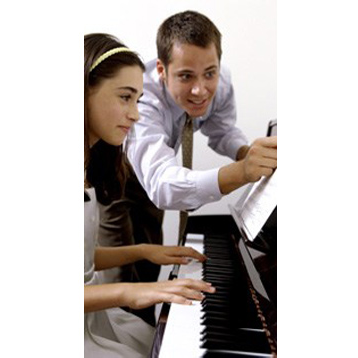 ManTeaching girl how to play the piano