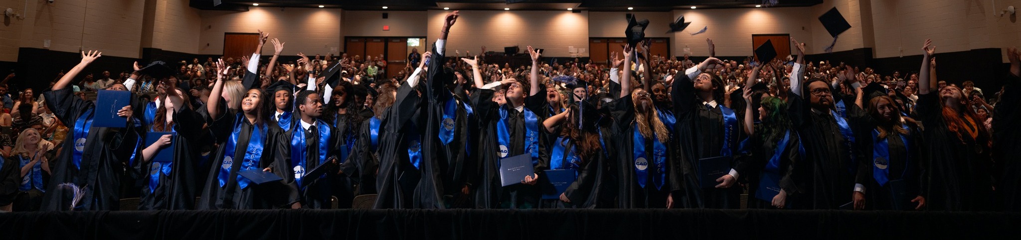 Seniors toss hats following graduation ceremony