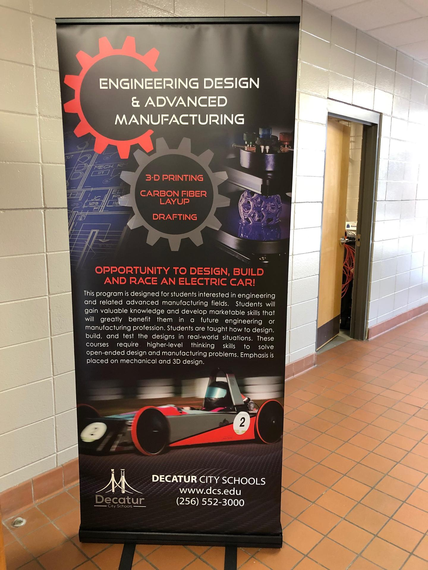 Engineering Design & Advanced Manufacturing banner that says 3d printing, carbon fiber layup, drafting Opportunity to design, build, and race an electric car. Decatur city schools