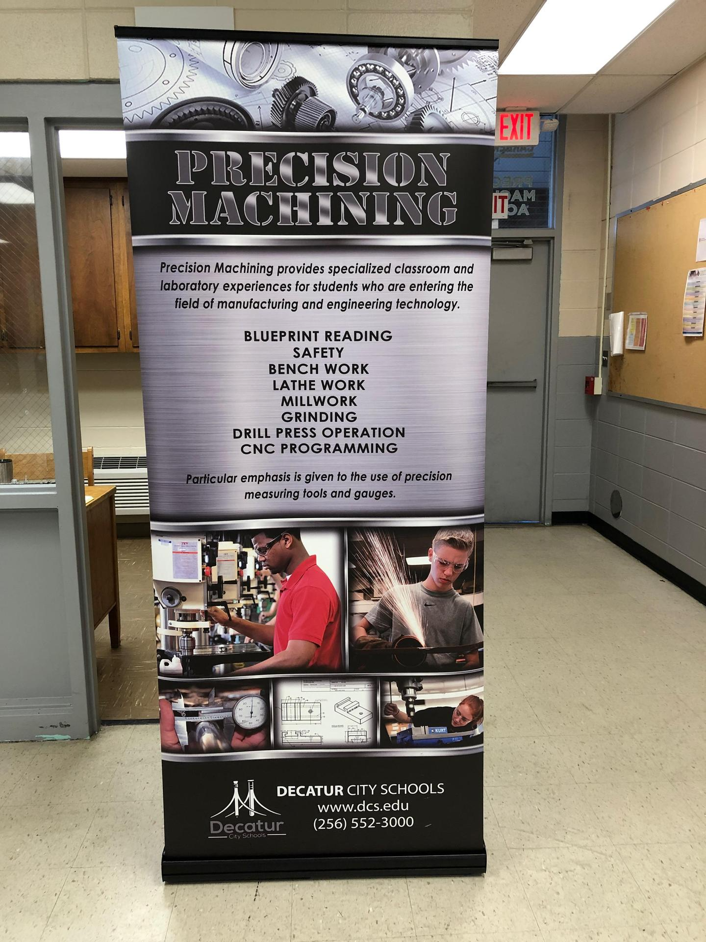 Precision Machining banner that says precision machining provides specialized classroom and lab experiences for students who are entering the field of manufacturing and engineering tech. blueprint reading, safety, bench work, lathe work, millwork, grinding, drill press operation, cnc programming. Particular emphasis is given to the use of precision measuring tools and guages. decatur city schools