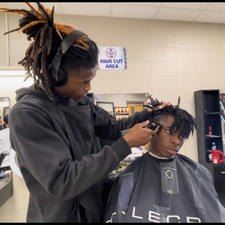 students learning barbering techniques