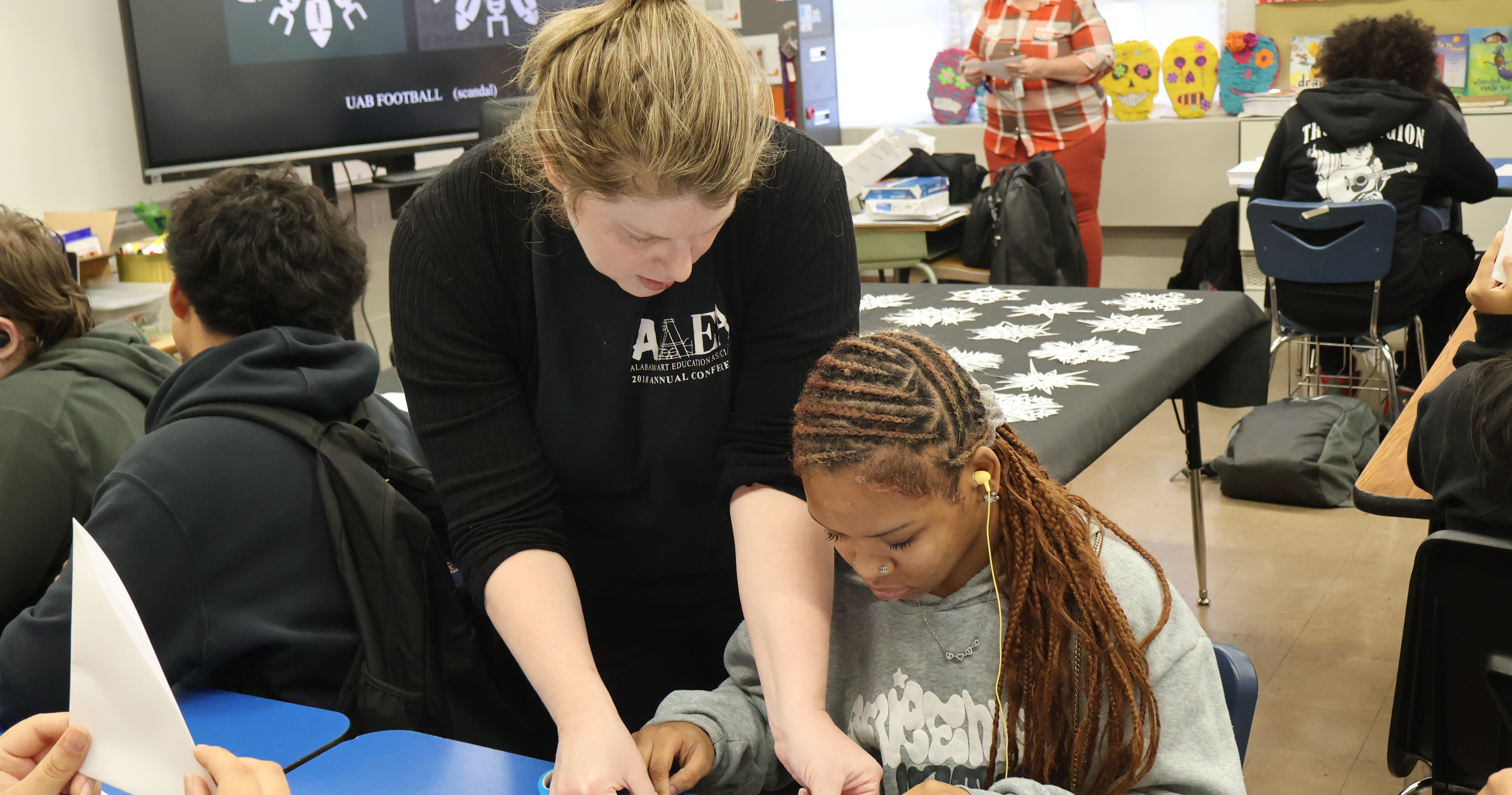 Austin Junior High School student enjoying learning about making paper snowflakes.