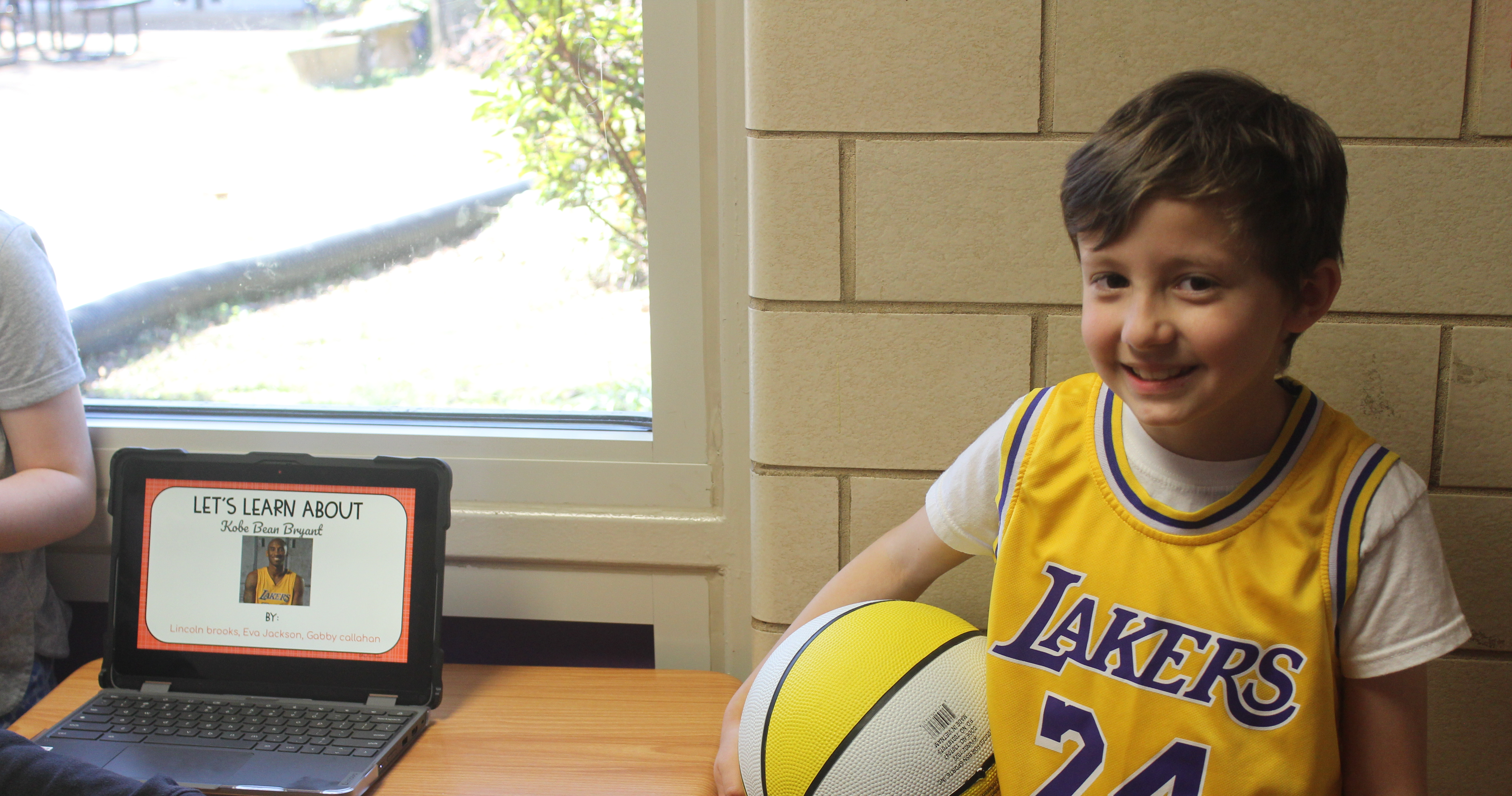 Student stands holding basketball