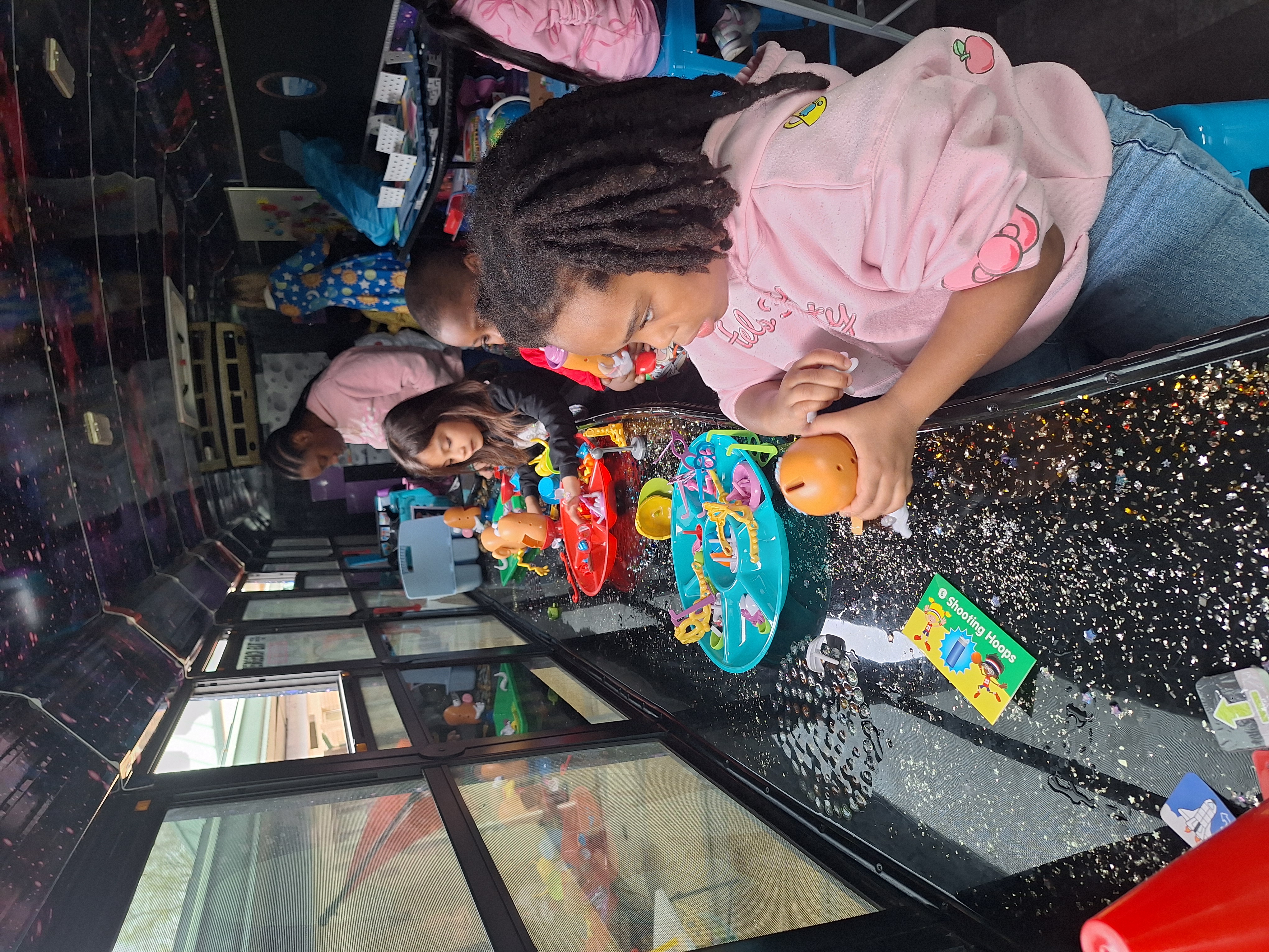 Images of Woodmeade Elementary students on the STEM Bus using manipulatives.