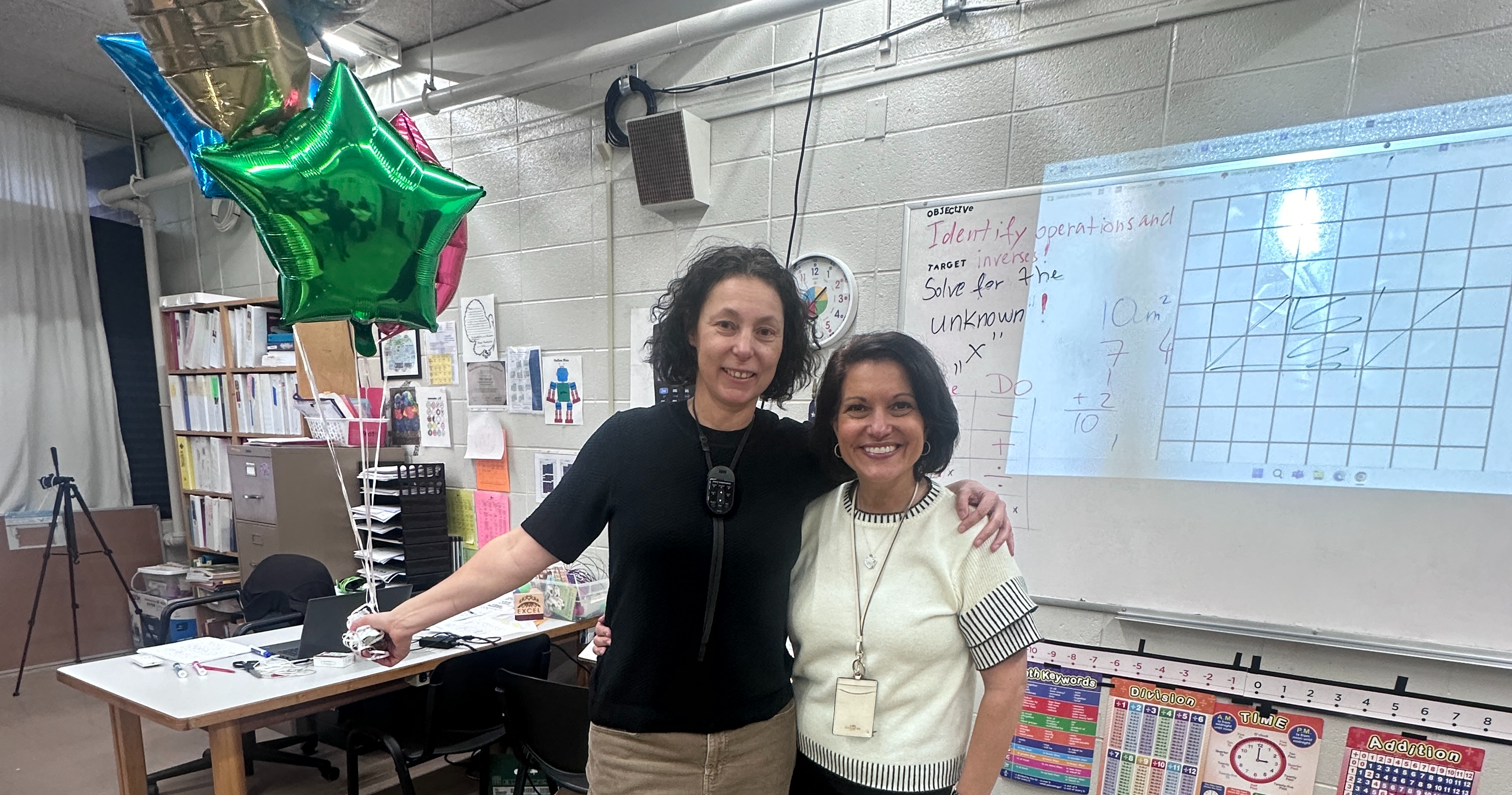 Ildiko Szebenyik holds a bouquet of balloons and poses with Mary Ann Hotaling as she is presented with Excel's Teacher of the Year Award.