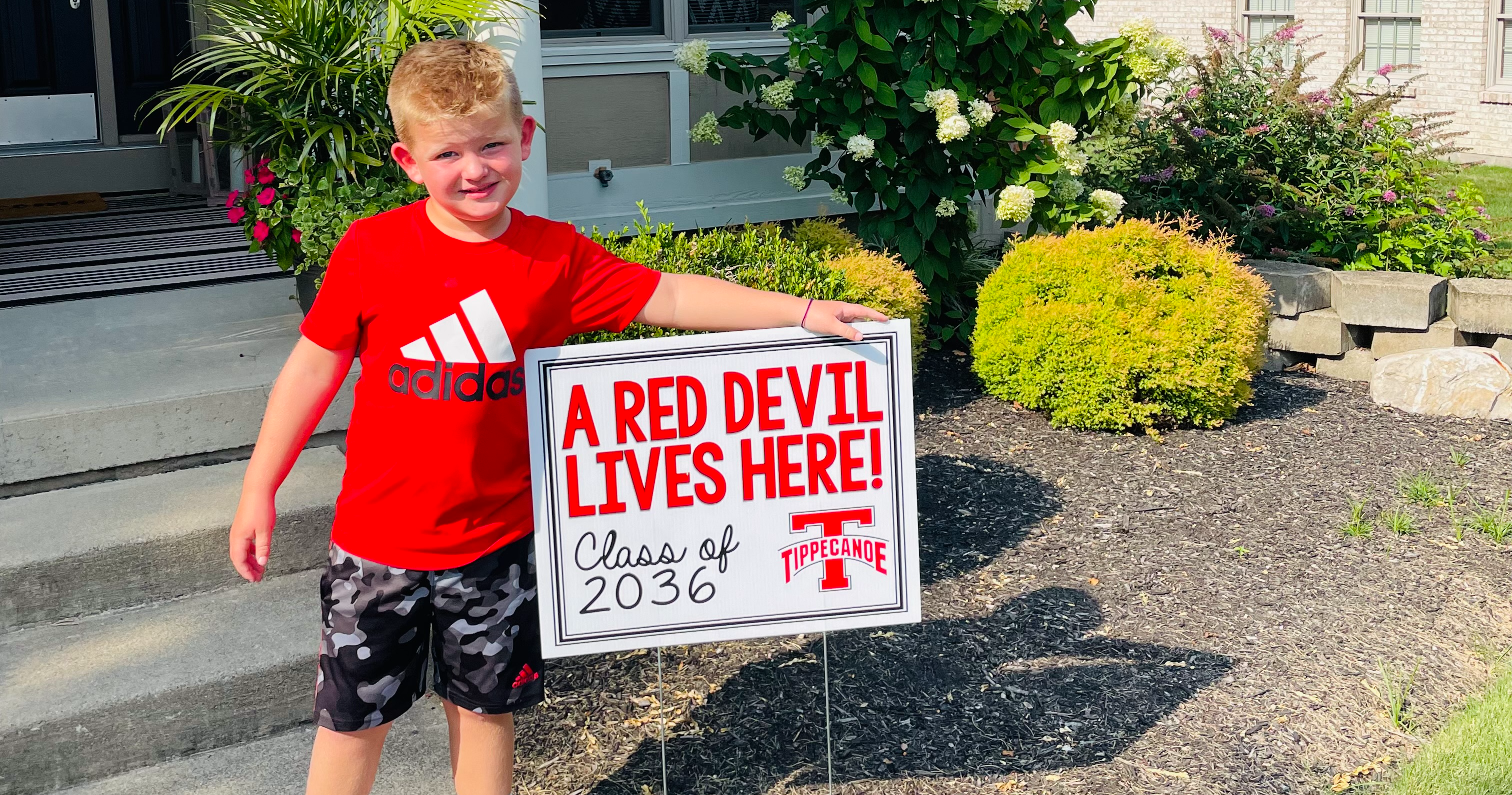 Kindergarten student with his new sign.  