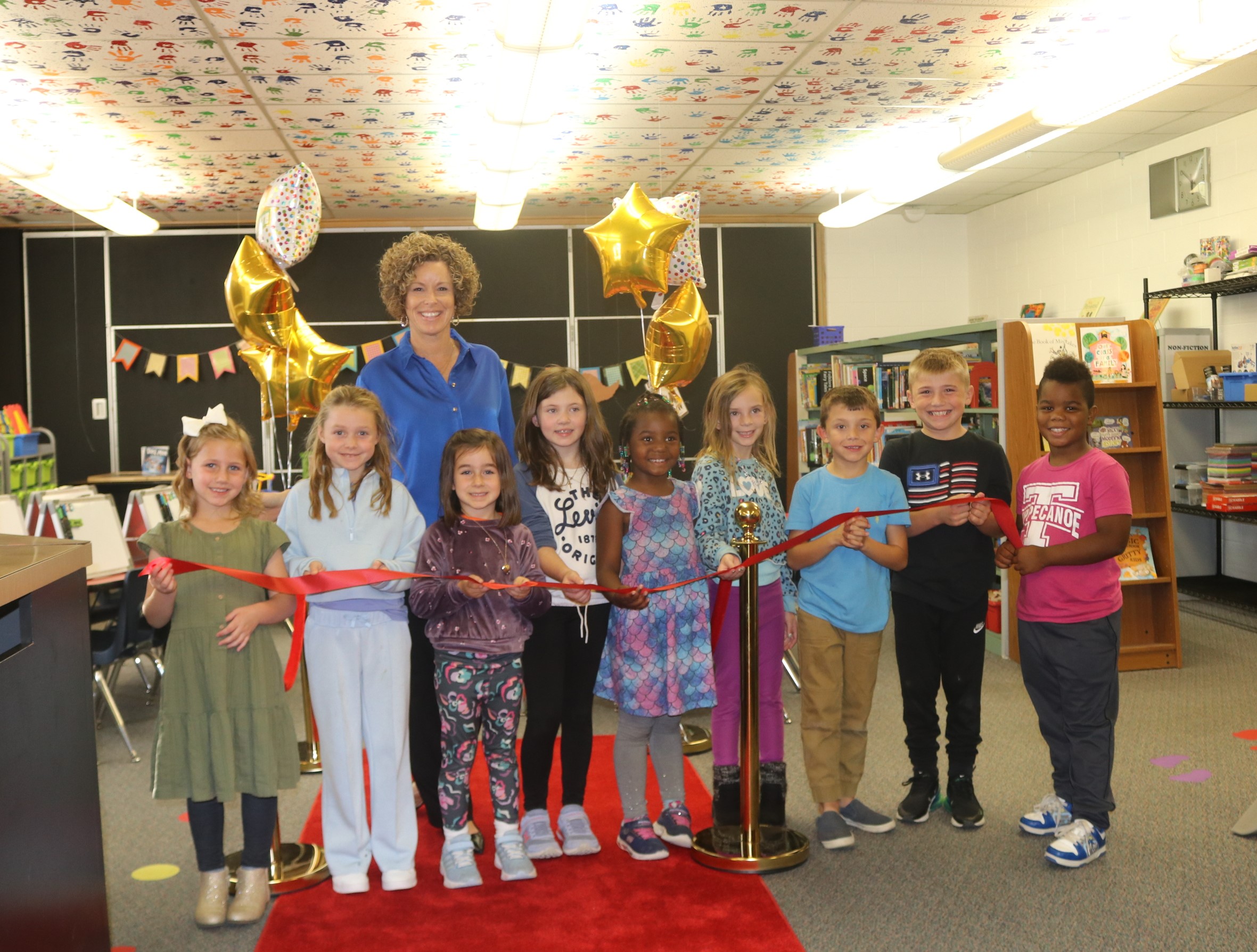 Students and Mrs. Smith at ribbon cutting.