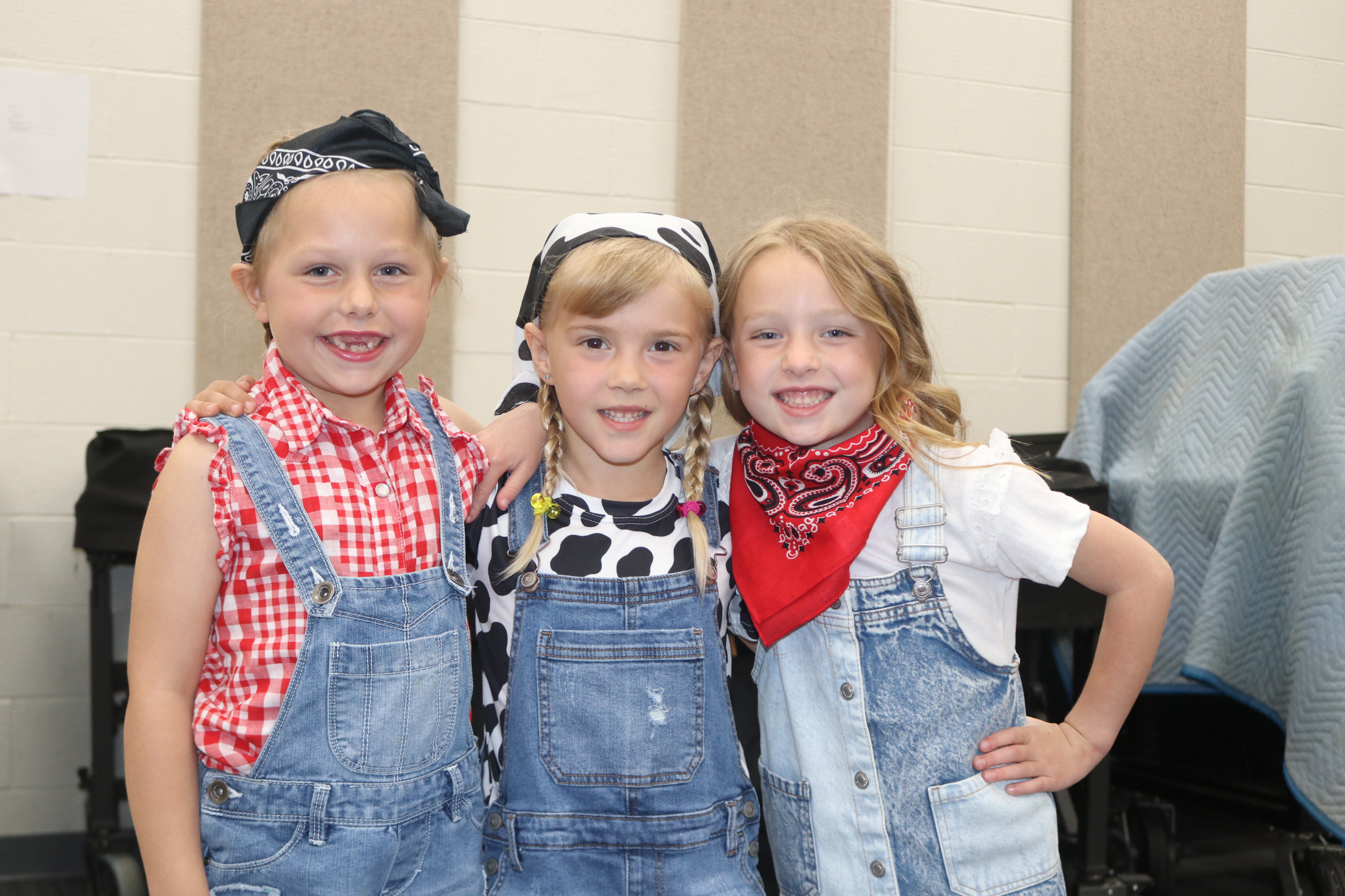 Three girls pose before the Moo-sical.  
