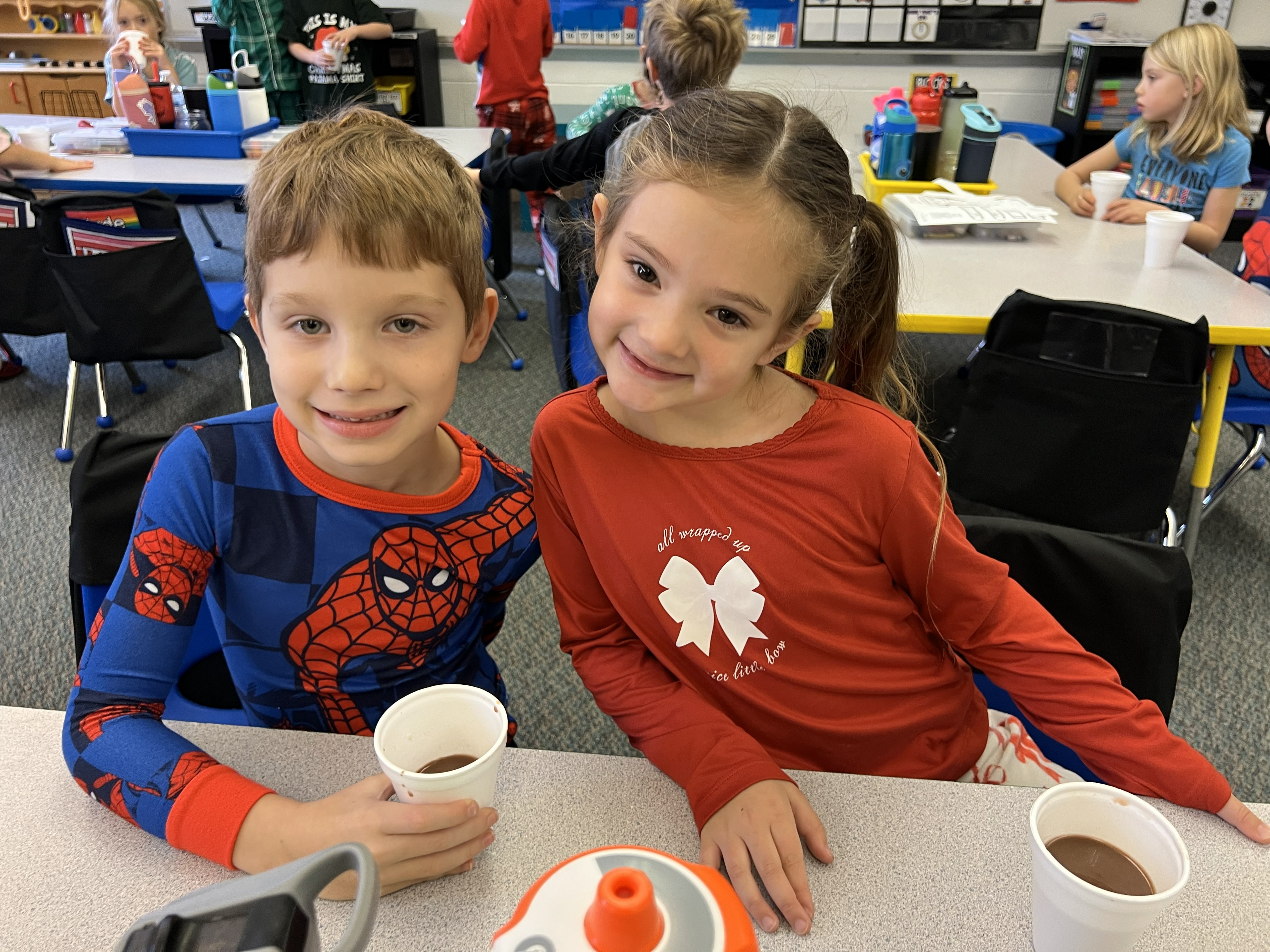 Two students with their hot chocolate during Polar Express.