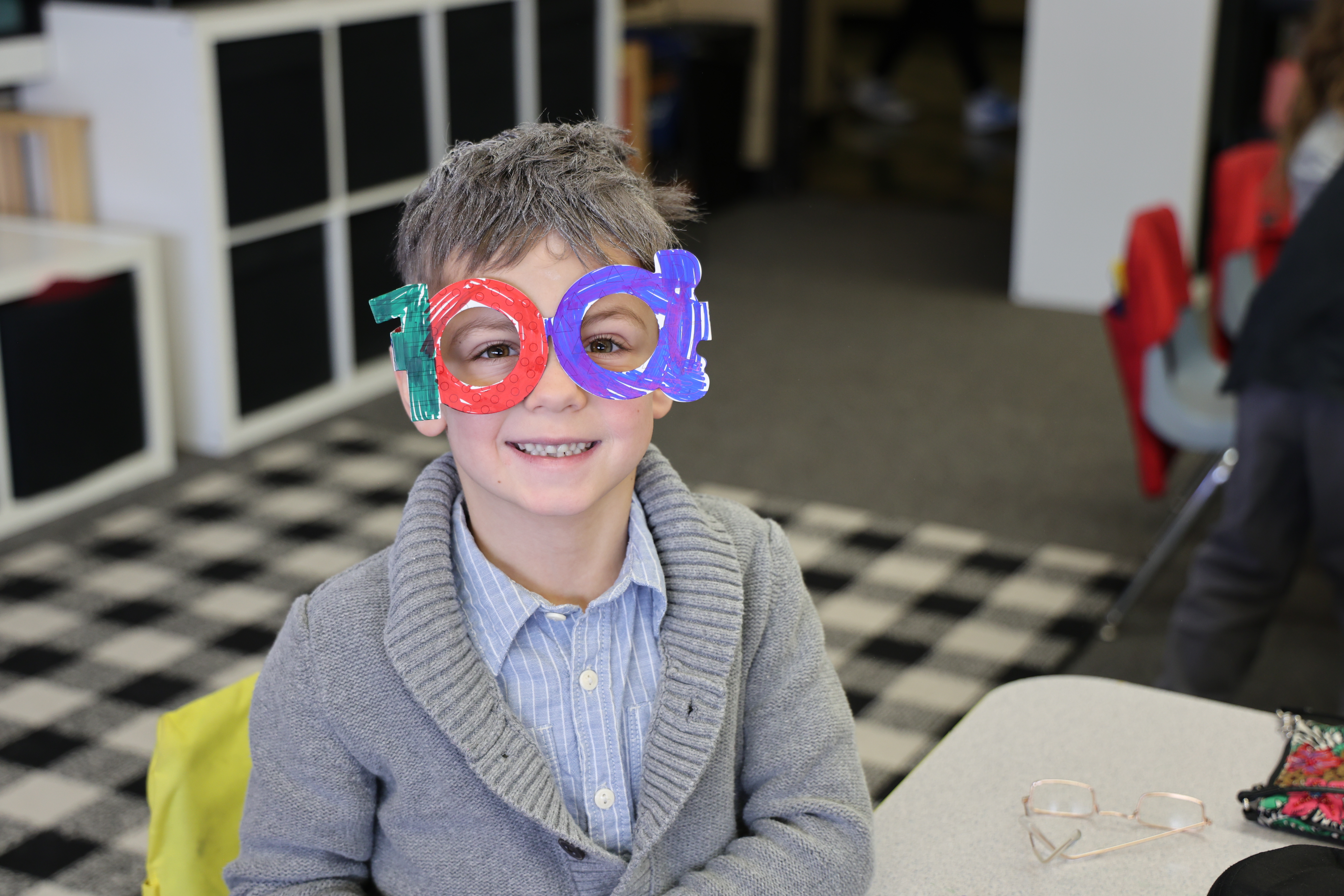 A kindergarten student with his 100 days glasses.