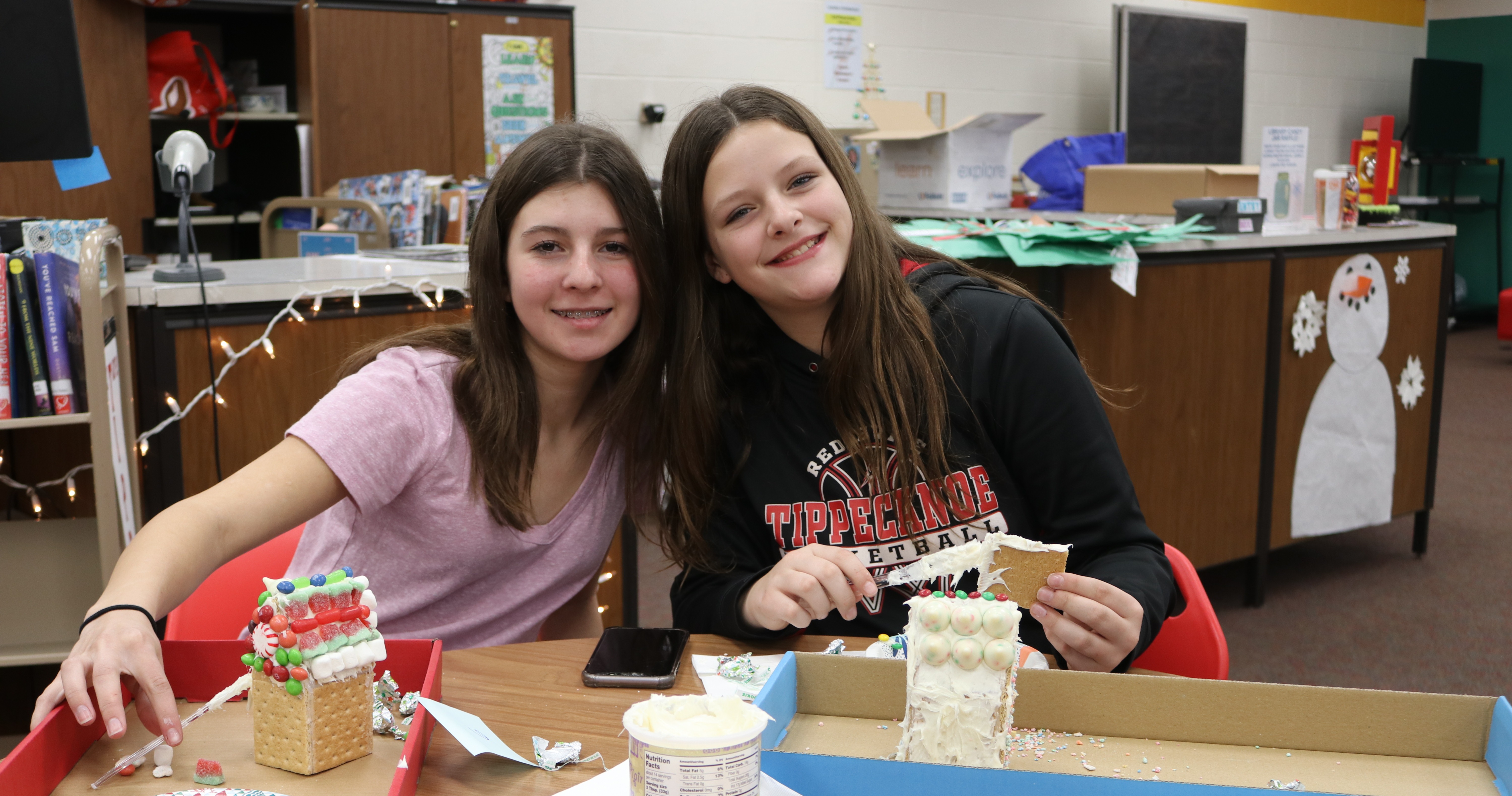 Two TMS students during the Gingerbread House Decorating Contest.
