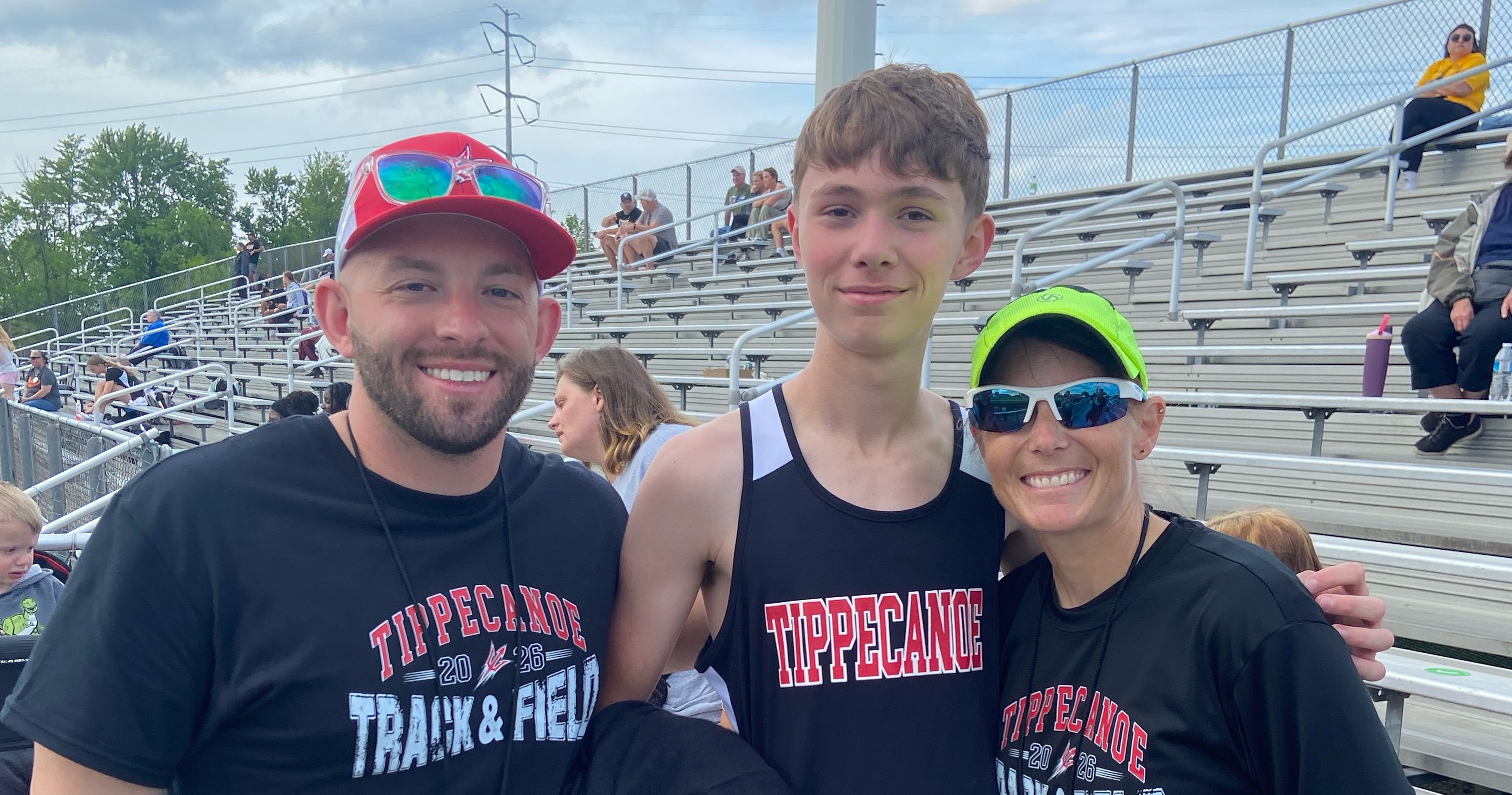 TMS student with his coaches after setting new school record.