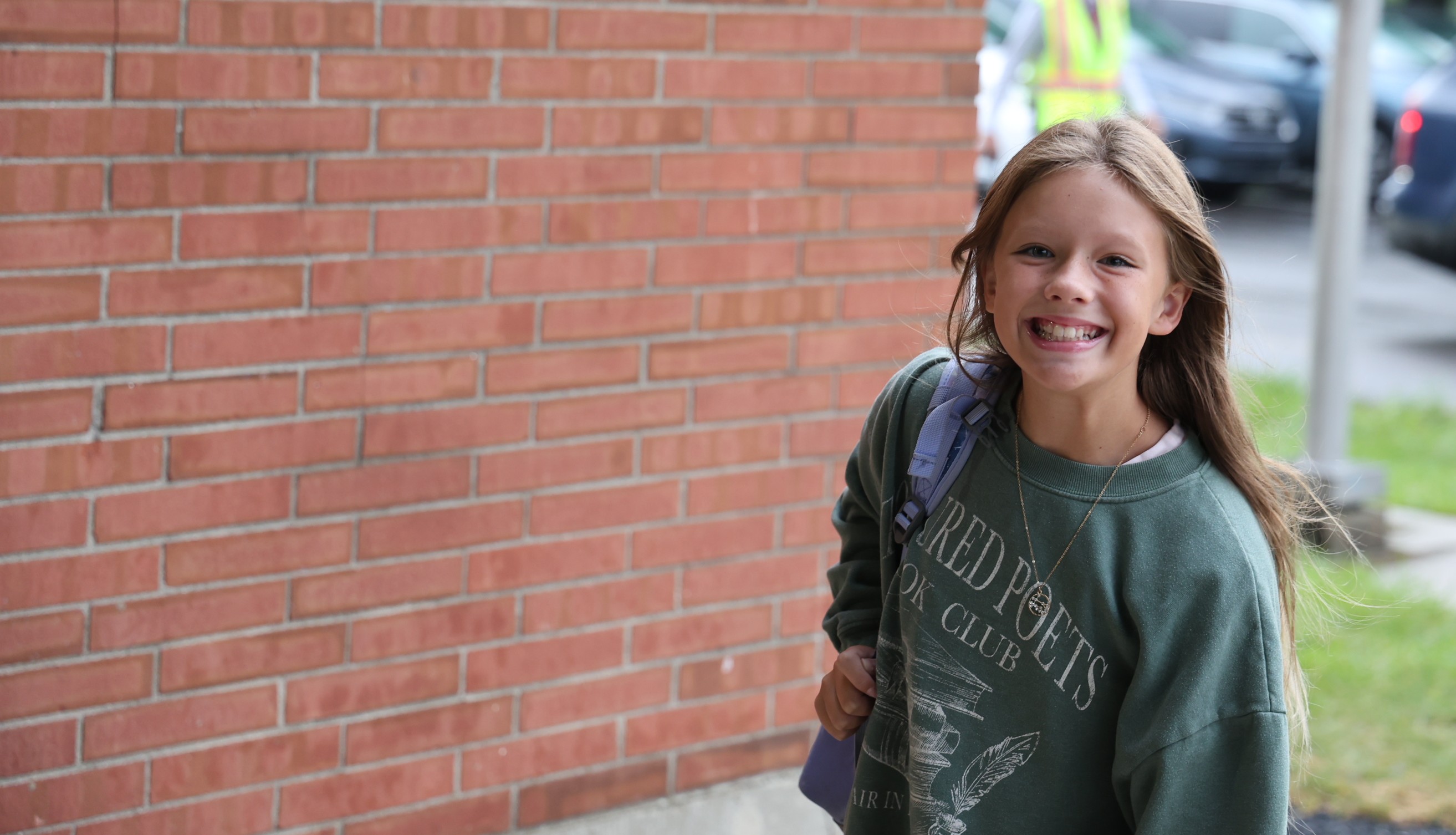 A TMS students walks into school on the first day of school with a huge smile. 