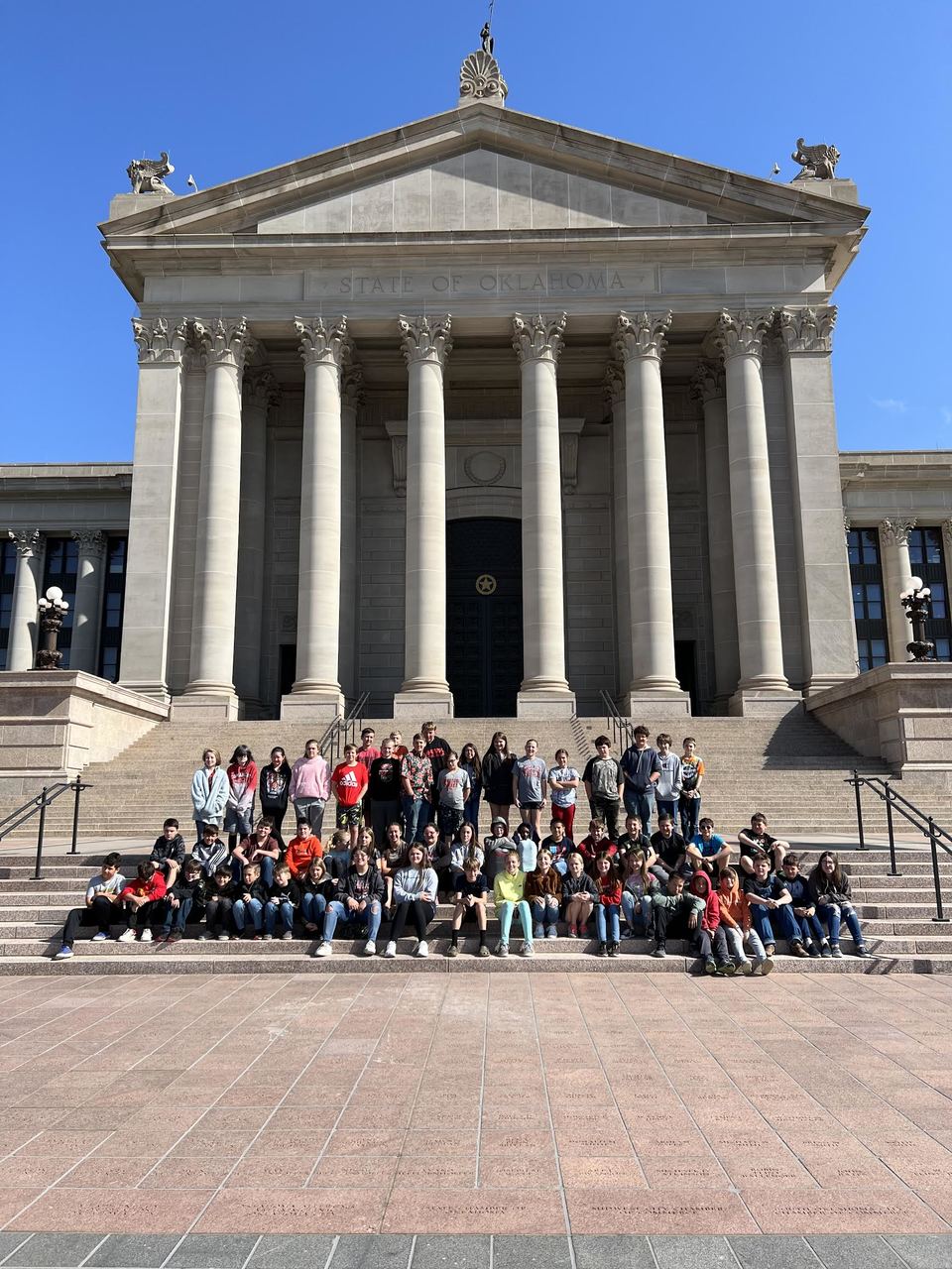 students in front of government building