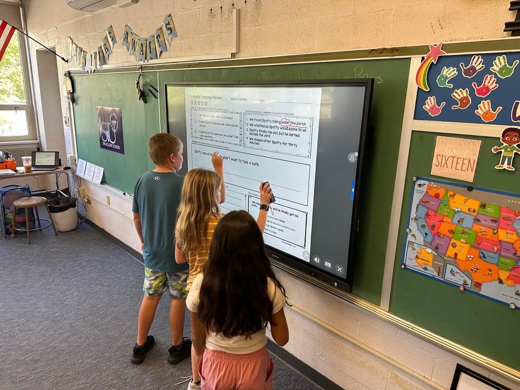 student at a touch board