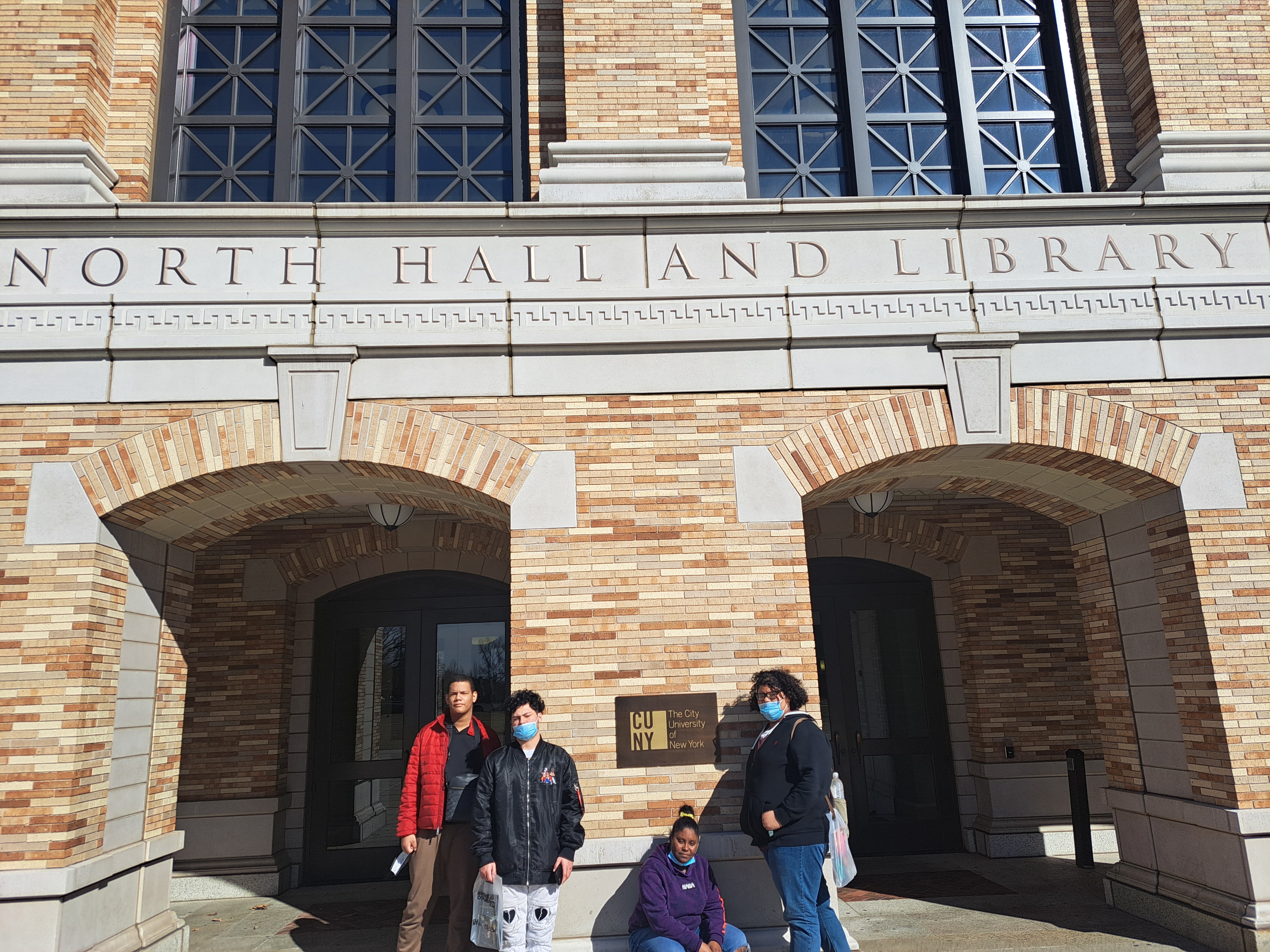 Students pose outside of the City university of new york north hall and library