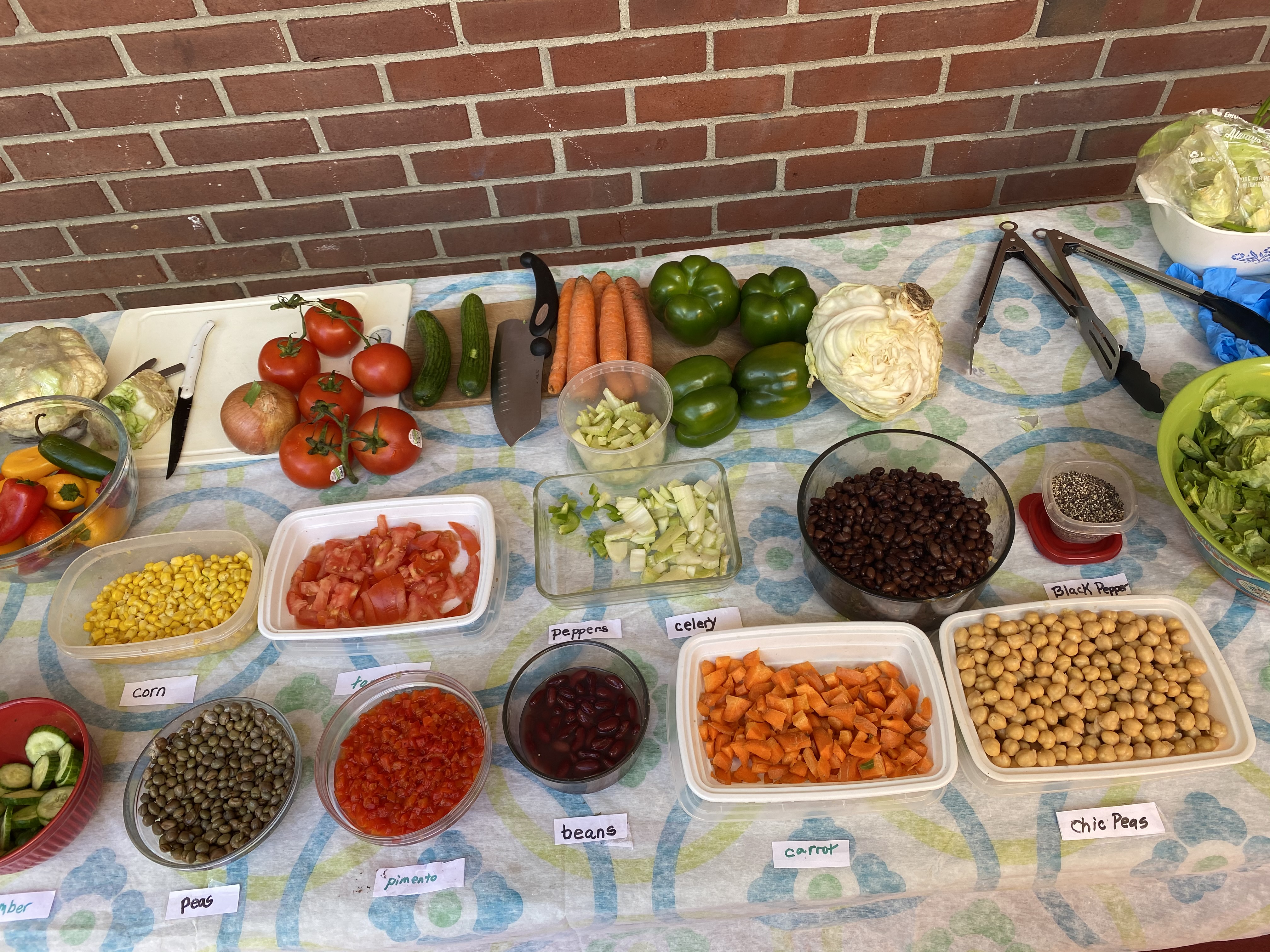 food laid out on a table in separate containers with each food labeled