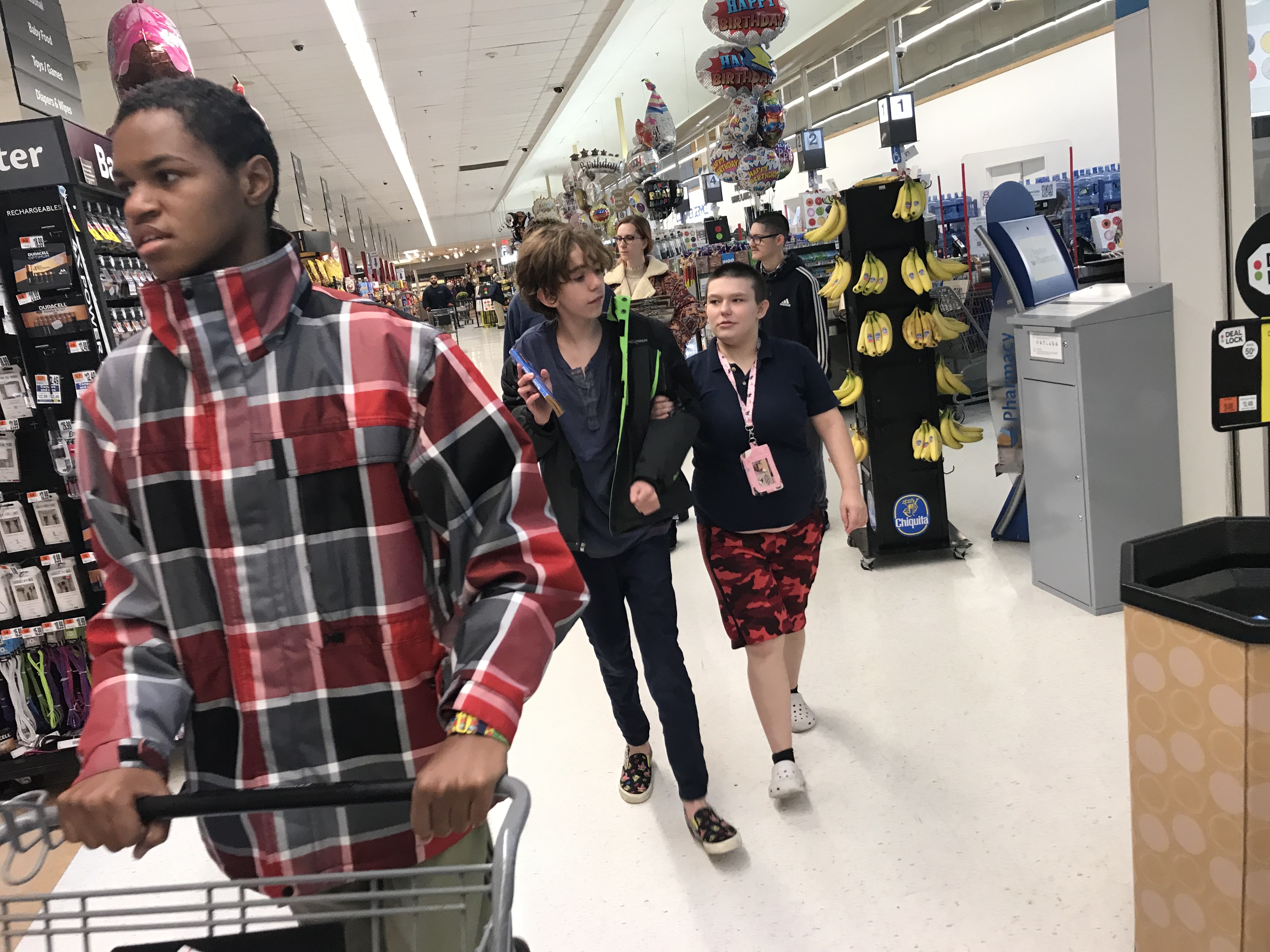 the class is shopping in a grocery store