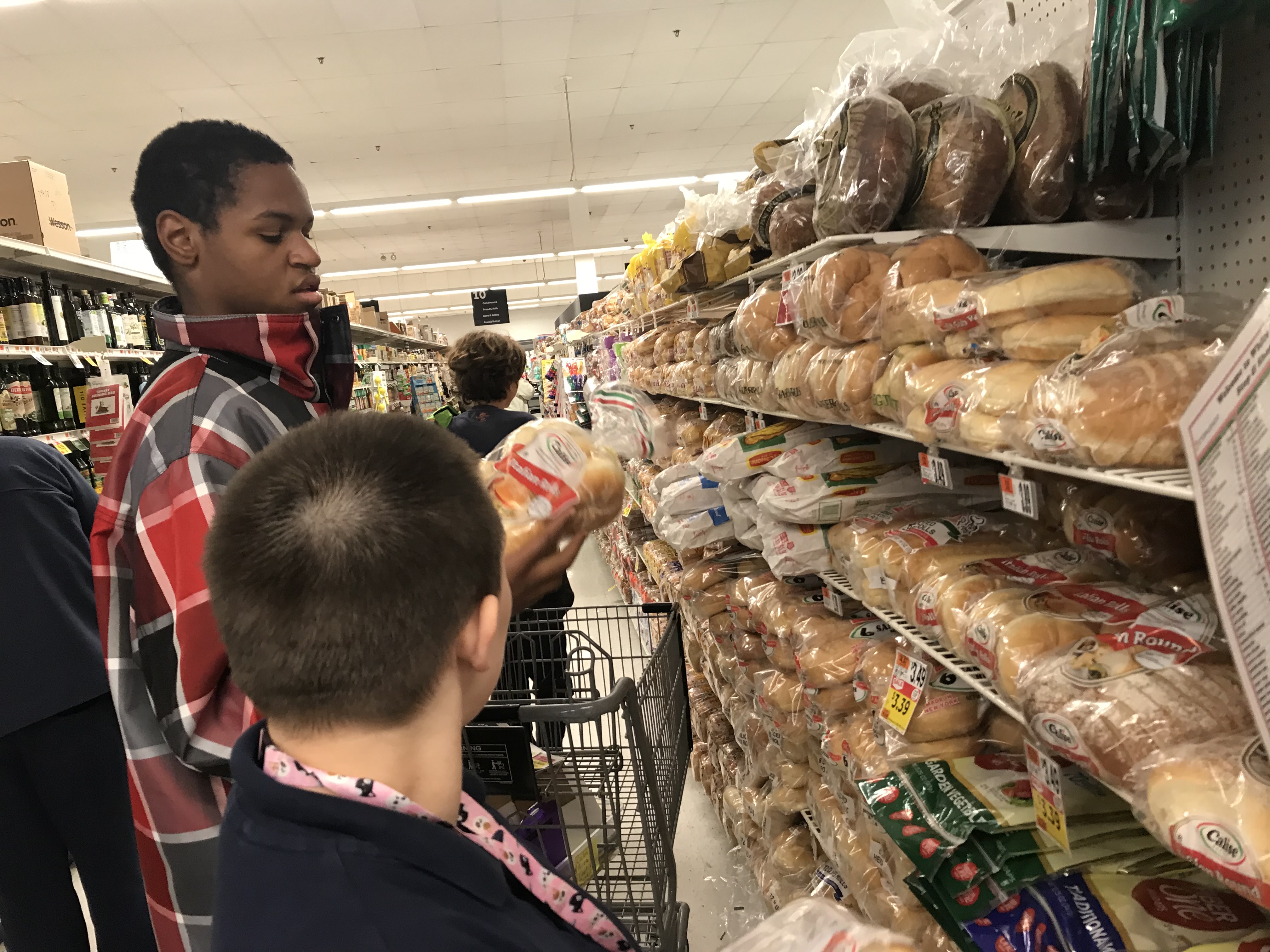 Students choose bread to purchase in the grocery store