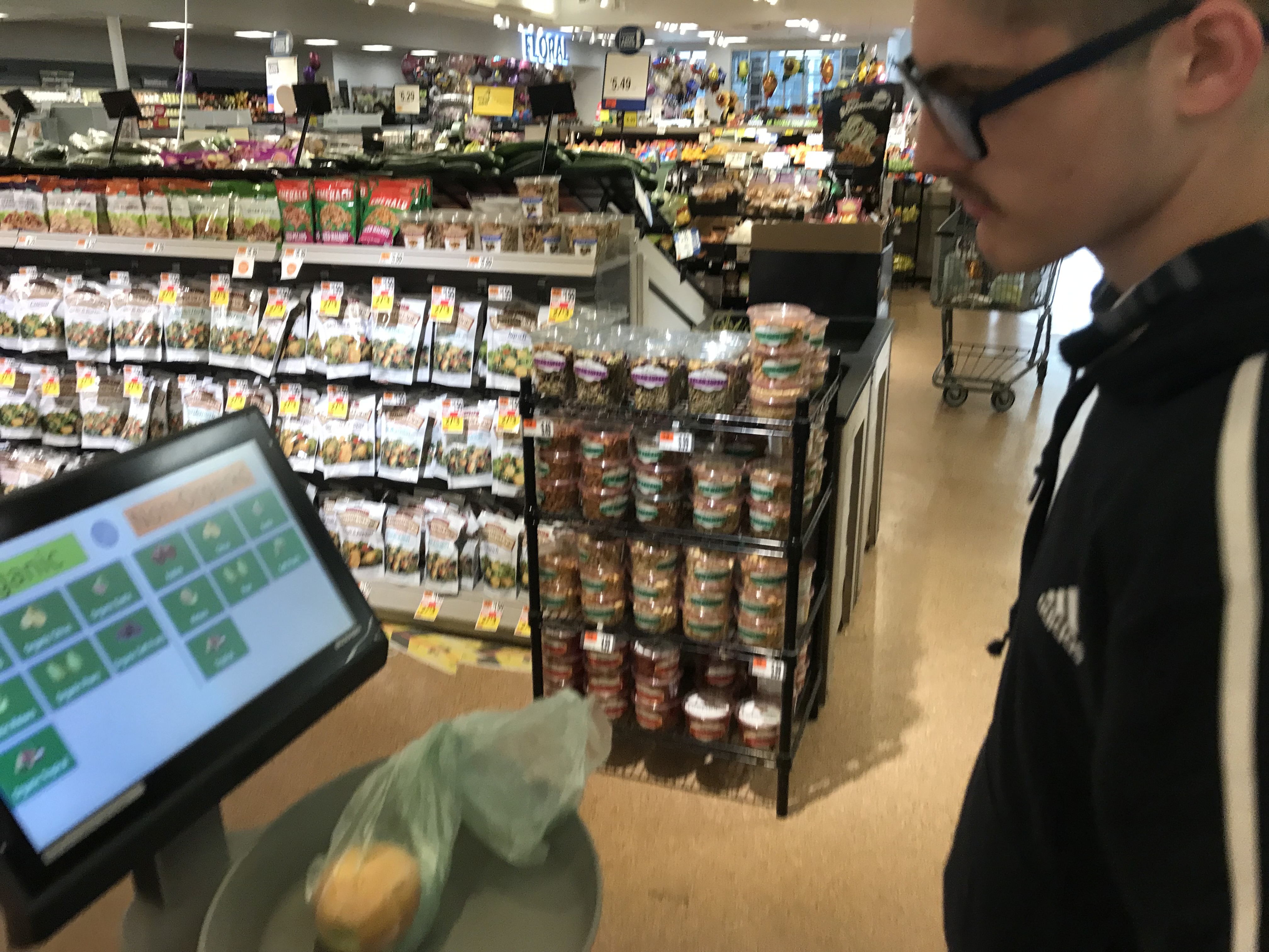A student enters food into the self check out