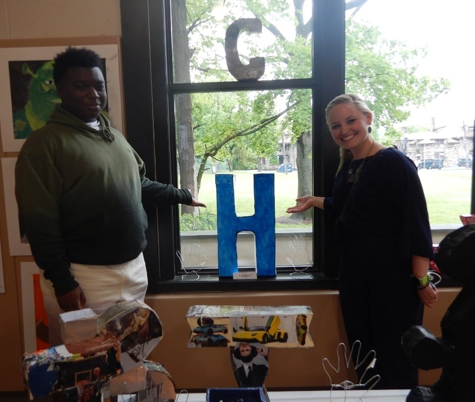 student and staff with art work