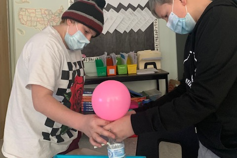 students filling a balloon