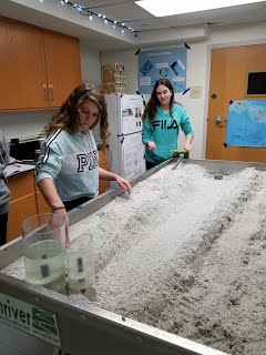 Chiara Skeelz and Mya Balanger setting up the stream table for their experiment on adhesion